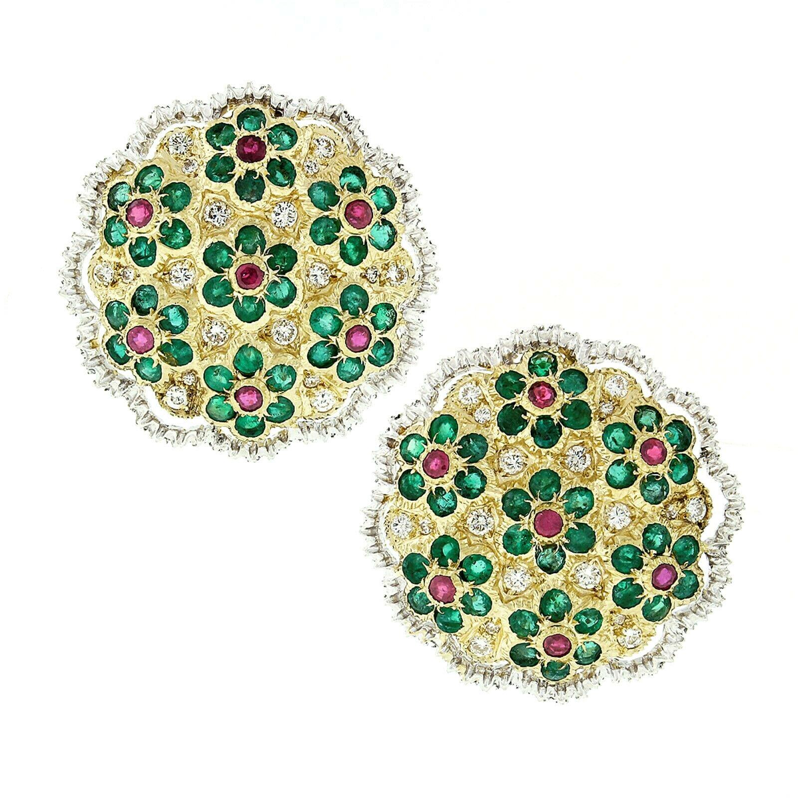 Here we have a truly breathtaking pair of large and colorful button earrings crafted in solid 18k gold featuring numerous daisy flowers, set with the finest quality natural emeralds, rubies and diamonds throughout. Each daisy flower consist of a