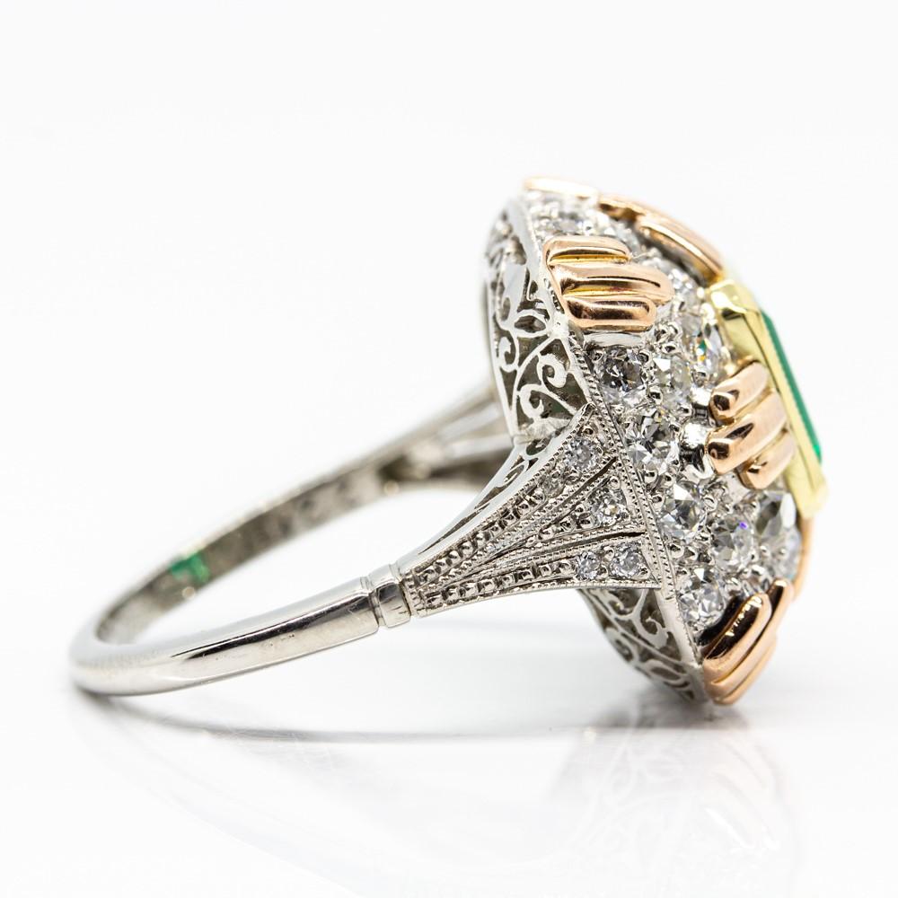 Composition: 18k Gold and Platinum
•	38 old mine cut diamonds of I-VS2 quality that weigh 1.15ctw.
•	1 natural Colombian emerald 1.11ctw
Ring size: 6 ¼ 
Ring face measurement: 18mm by 18mm
Height: 9mm
Total weight: 7.6 grams – 5dwt
