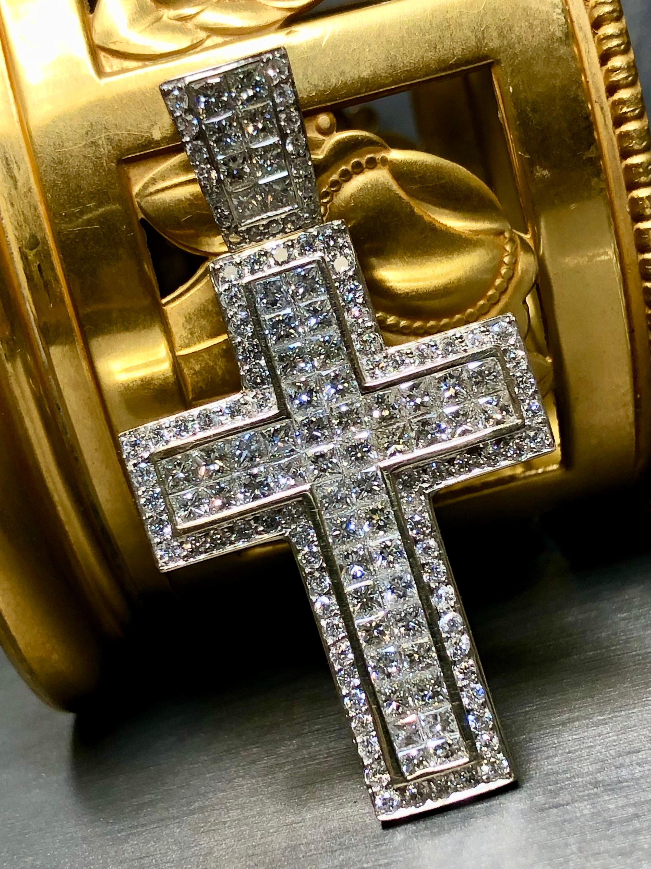 A very impressive crucifix pendant done in heavy 18K white gold and set with approximately 9.30cttw in princess cut and round diamonds. The princess cuts range G-H color and Vs1-2 clarity while the round diamonds are the same color and Vs2-si1 in