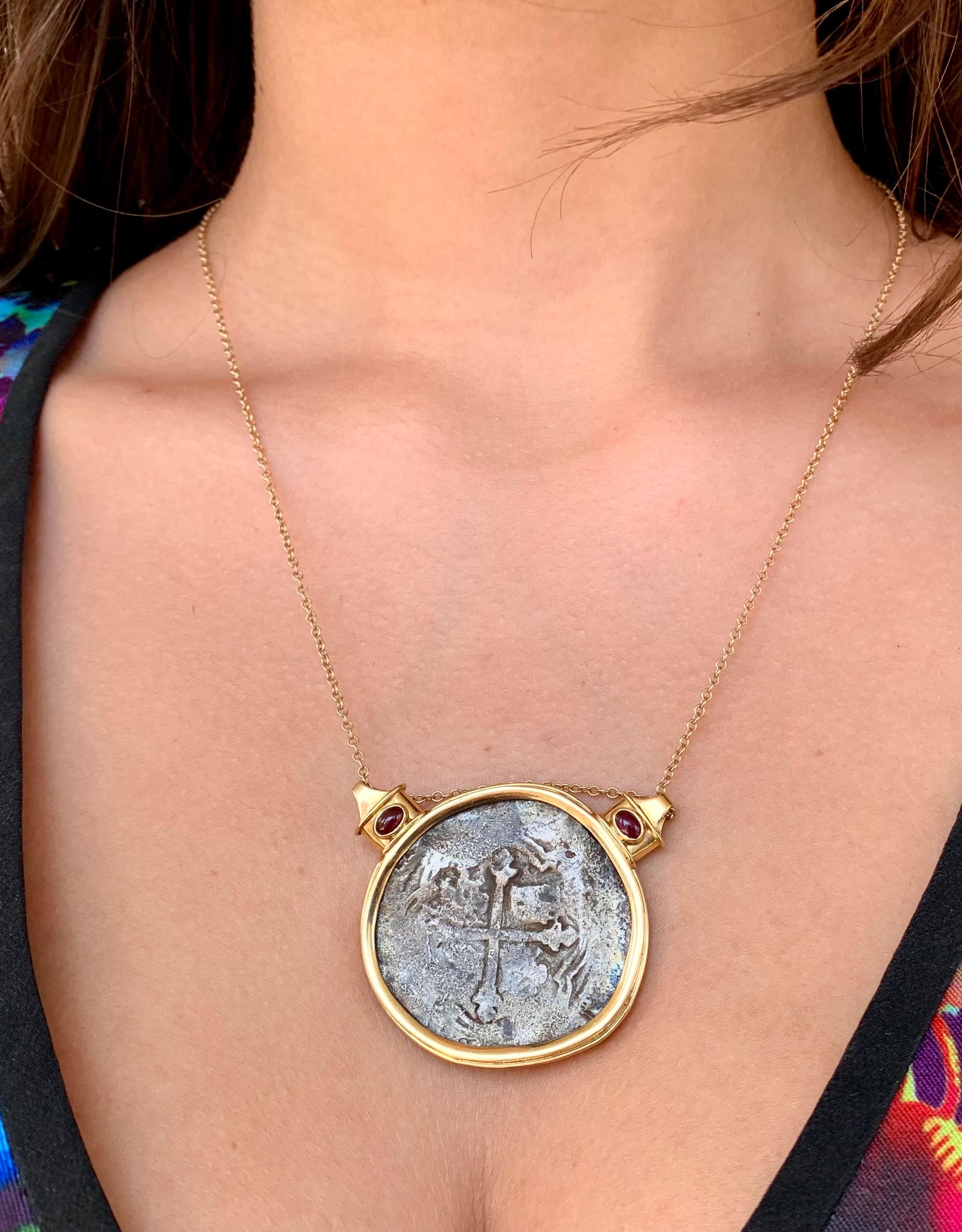 Large, beautiful coin pendant featuring a period 17th century Spanish 8 Reales coin from the Santa Margarita, the famed galleon shipwrecked in 1622 near Key West. Attractively set in a substantial 18K hand made setting with two oval cabochon rubies.