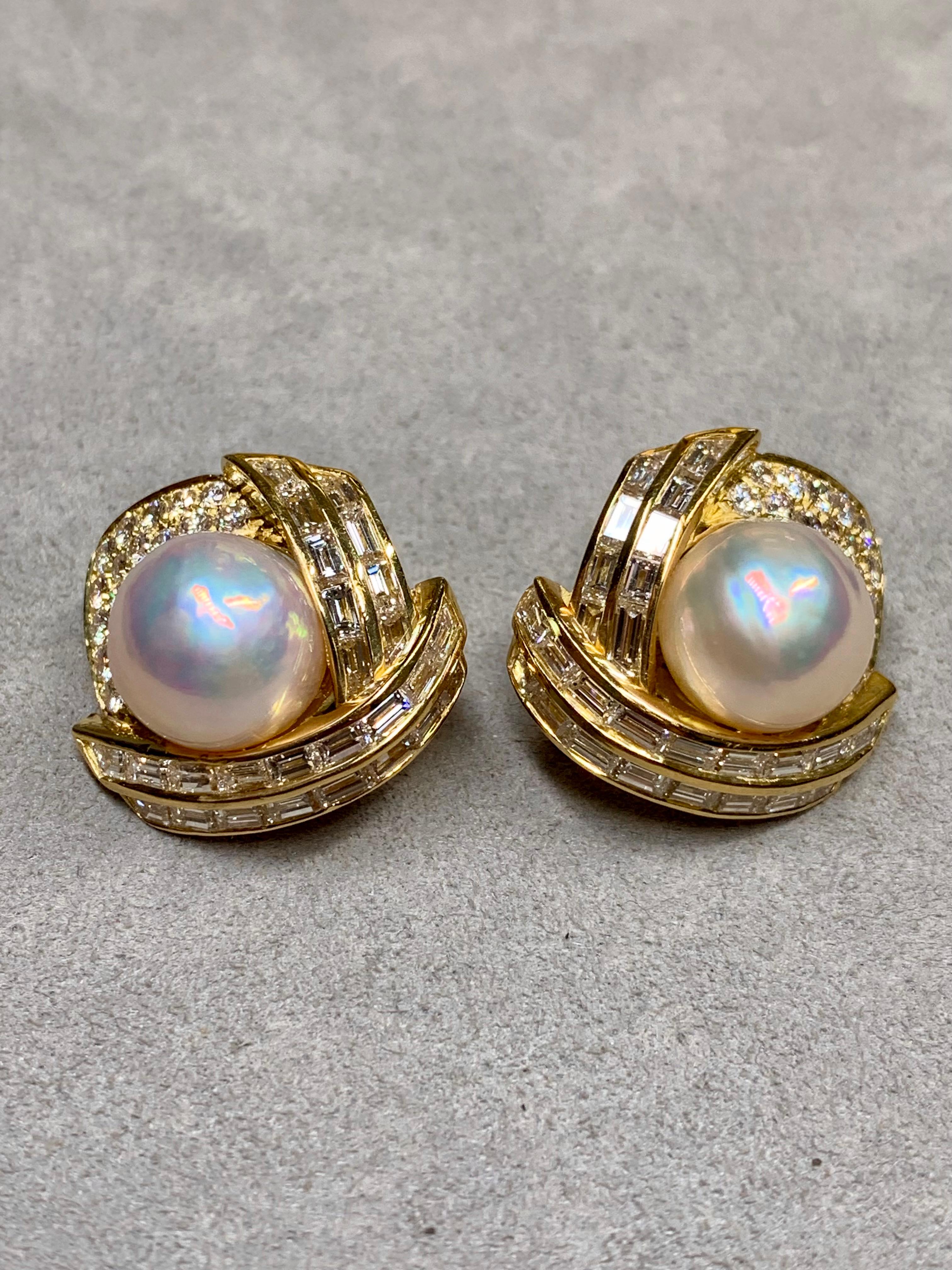 A fabulous pair of ear clips by well known American maker, Hammerman Brothers. They are crafted in 18K yellow gold a both channel and pavé set with approximately 6.92ctw in F-H color Vs1-2 clarity baguette and round diamonds. They are set with 12mm