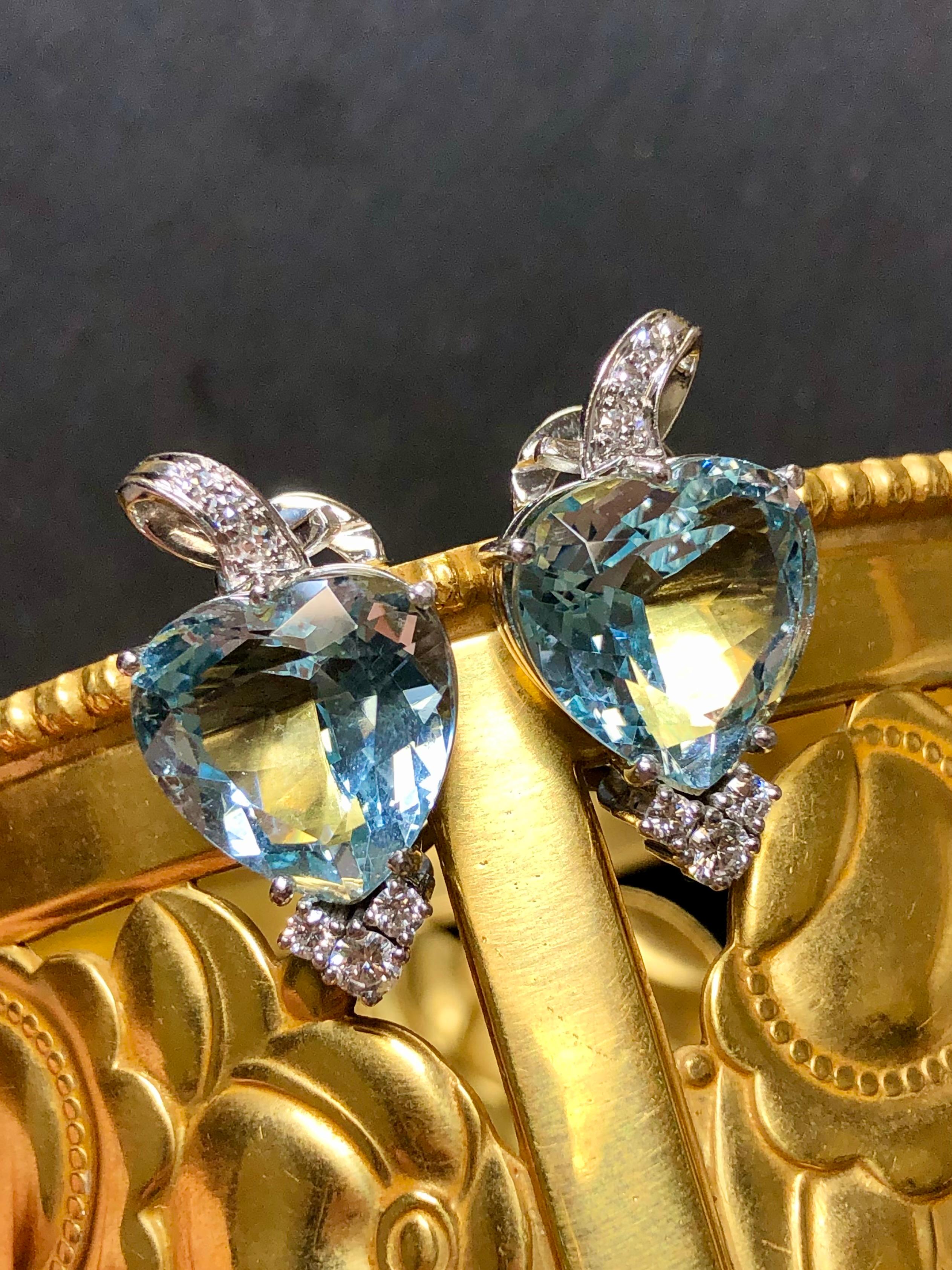 
A gorgeous pair of huggies done in 18K white gold (yellow gold posts) centered by approximately 14.80cttw (7.40ct each) in heart shape natural blue aquamarines accompanied by approximately .44cttw in G-H color Vs1-2 clarity round