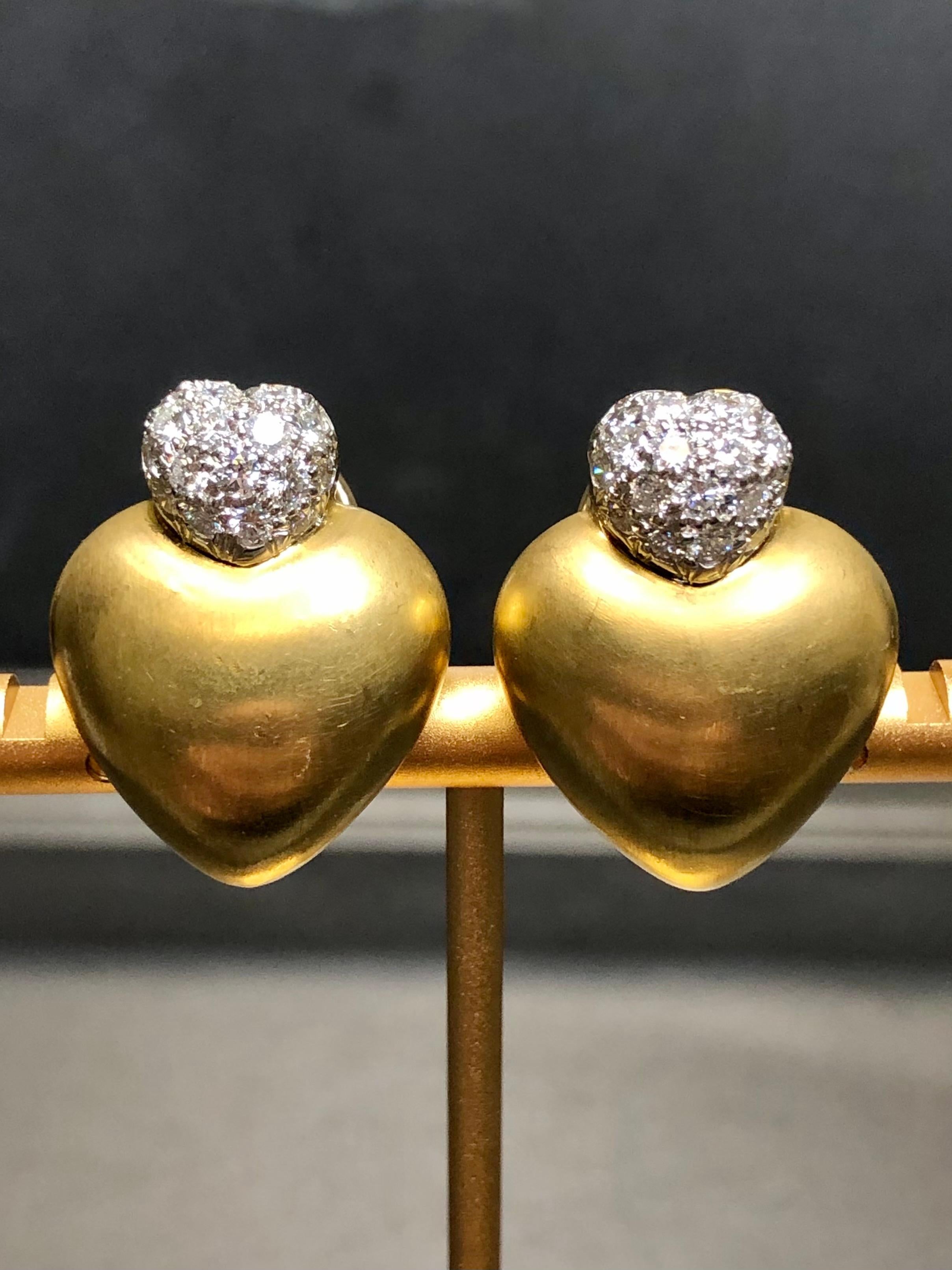 An original pair of clip-on huggies by designer Marlene Stowe done in 18K yellow gold and set with approximately 1.50cttw in G-H color Vs1-2 clarity round diamonds.


Dimensions/Weight:

Earrings measure 1” by .75” in diameter and weigh