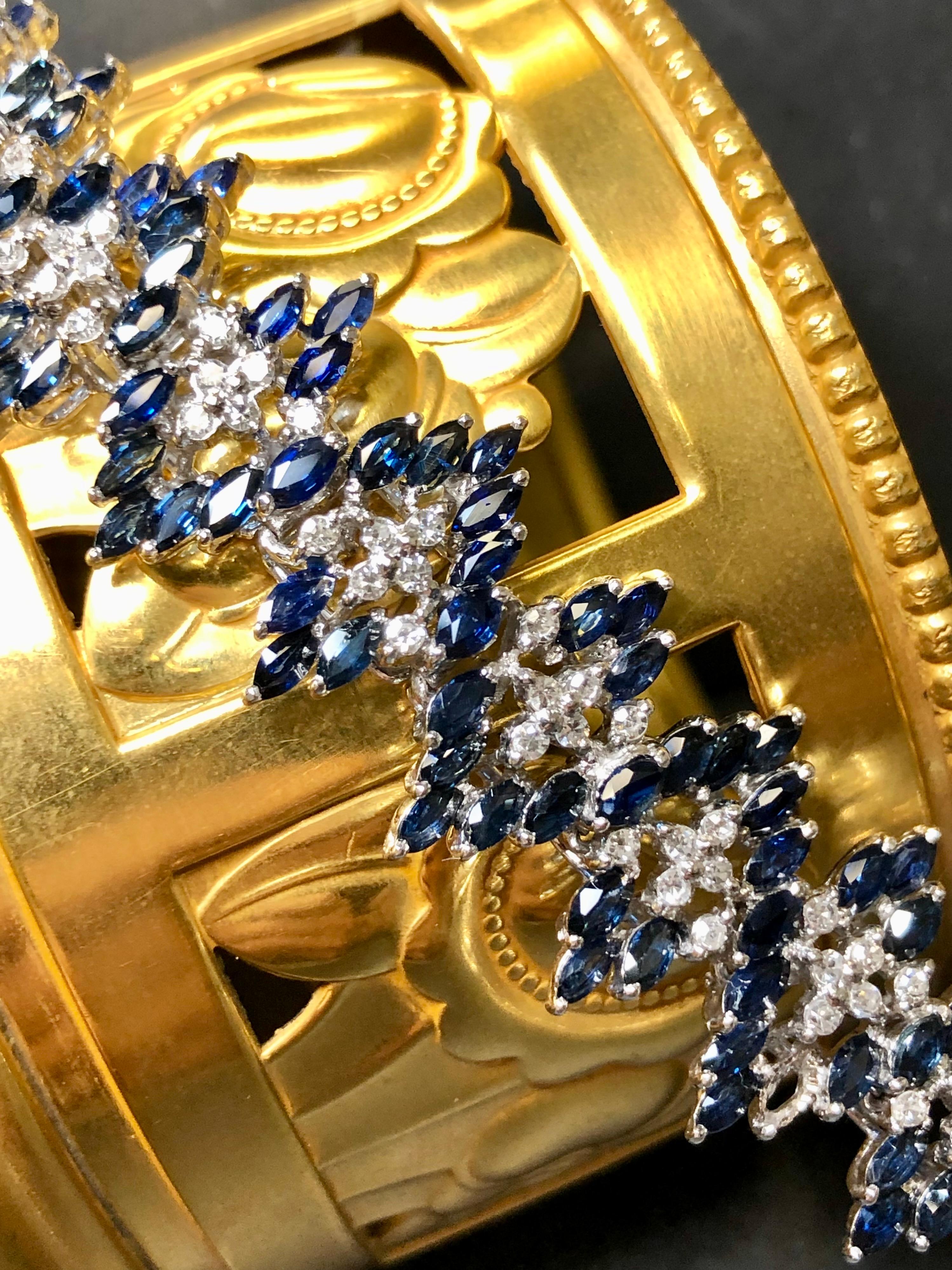 Ce bracelet large en or blanc 14 carats est serti d'environ 2.28cttw de diamants ronds de couleur G-H Vs1-Si1 ainsi que de 7.10cttw de saphirs naturels bleu royal taillés en marquise. Une pièce magnifiquement fabriquée à la main qui ne manquera pas