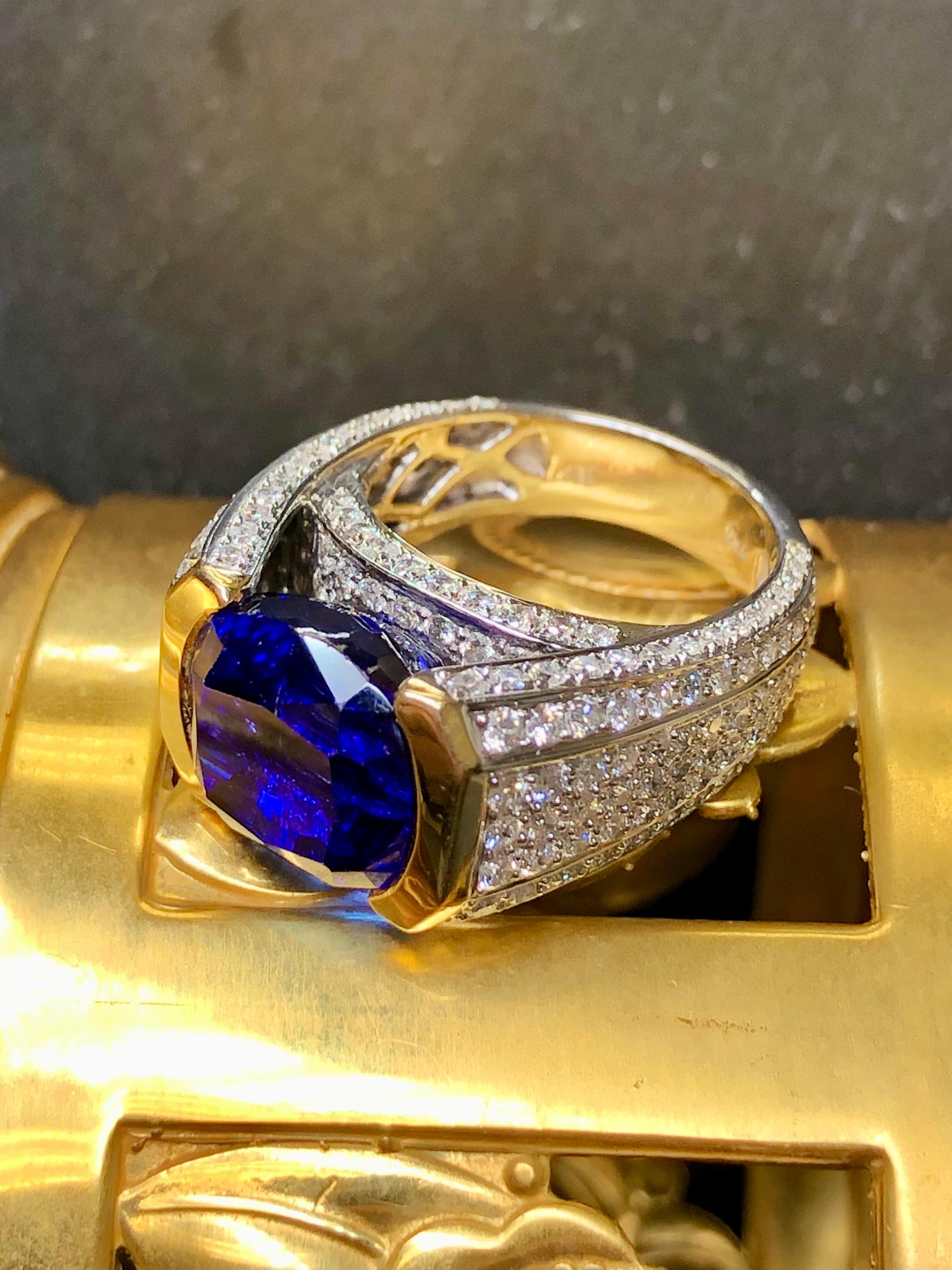 A substantial and well made cocktail ring that is surely to become your new showstopper piece! It is done in 18K white and yellow gold and centered by an approximately 10.25ct tanzanite (11.60mm x 11.30mm x 9mm) with another 3cttw in G-H color Vs1-2
