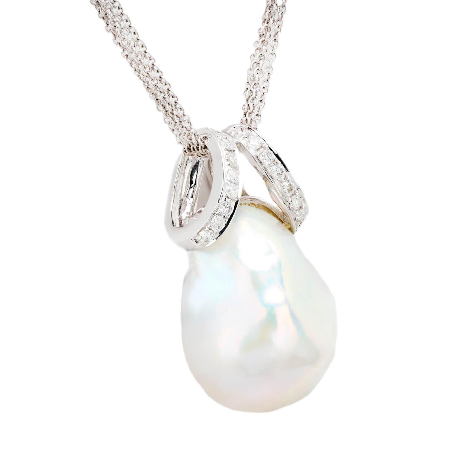 An absolutely gorgeous pearl and diamond pendant necklace! Crafted in 18k white gold, this piece features a large pearl pendant. The large pearl displays a marvelous, eye-catching luster and is attached to a complementary bail. The bail is encrusted