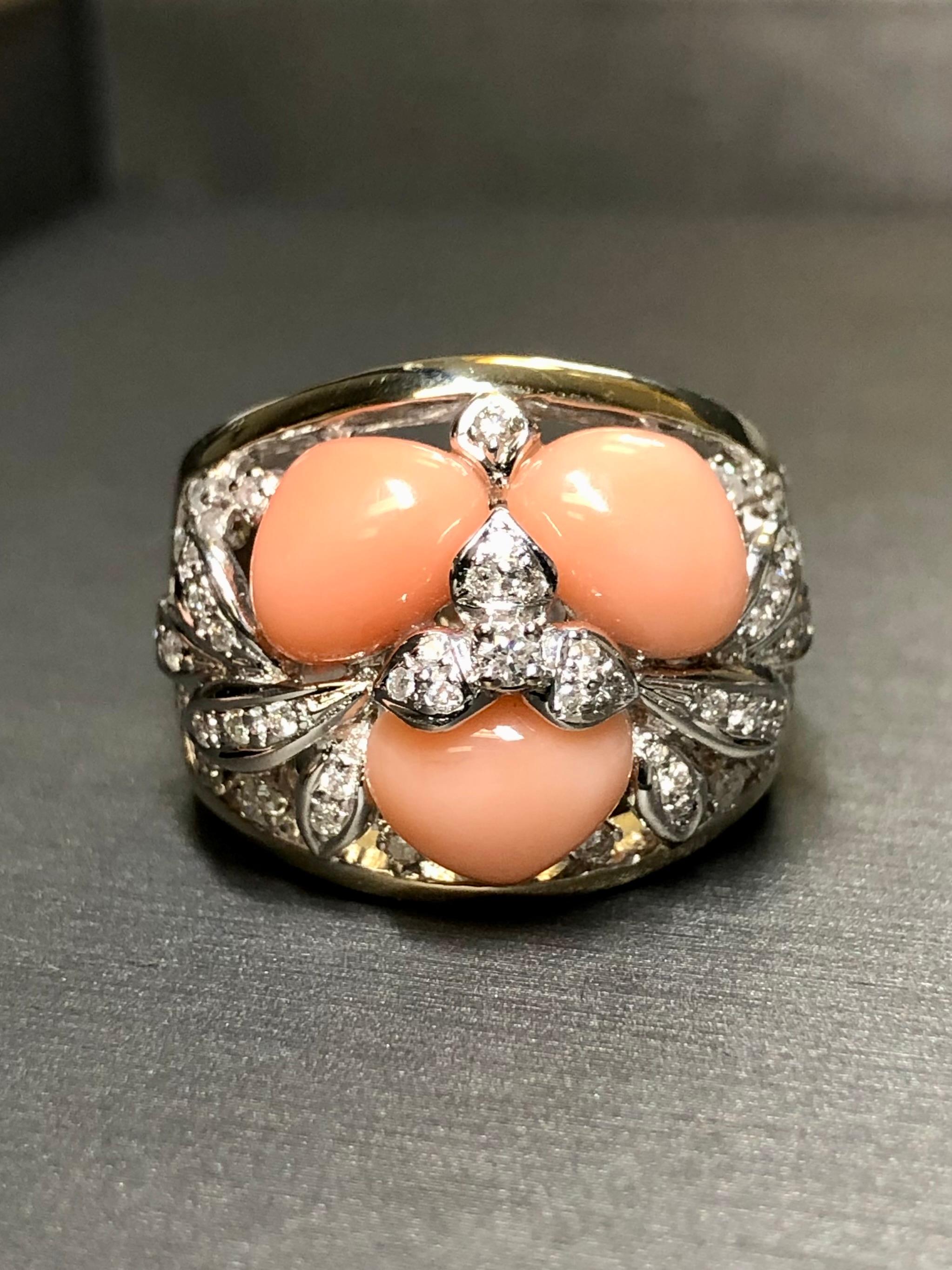 
A bold statement ring done in 18K white gold and set with the three polished coral cabochons surrounded by approximately .60cttw in H-J color Si2-i2 clarity rounds diamonds.


Dimensions/ Weight:

Ring measures .75” wide and the top and weighs