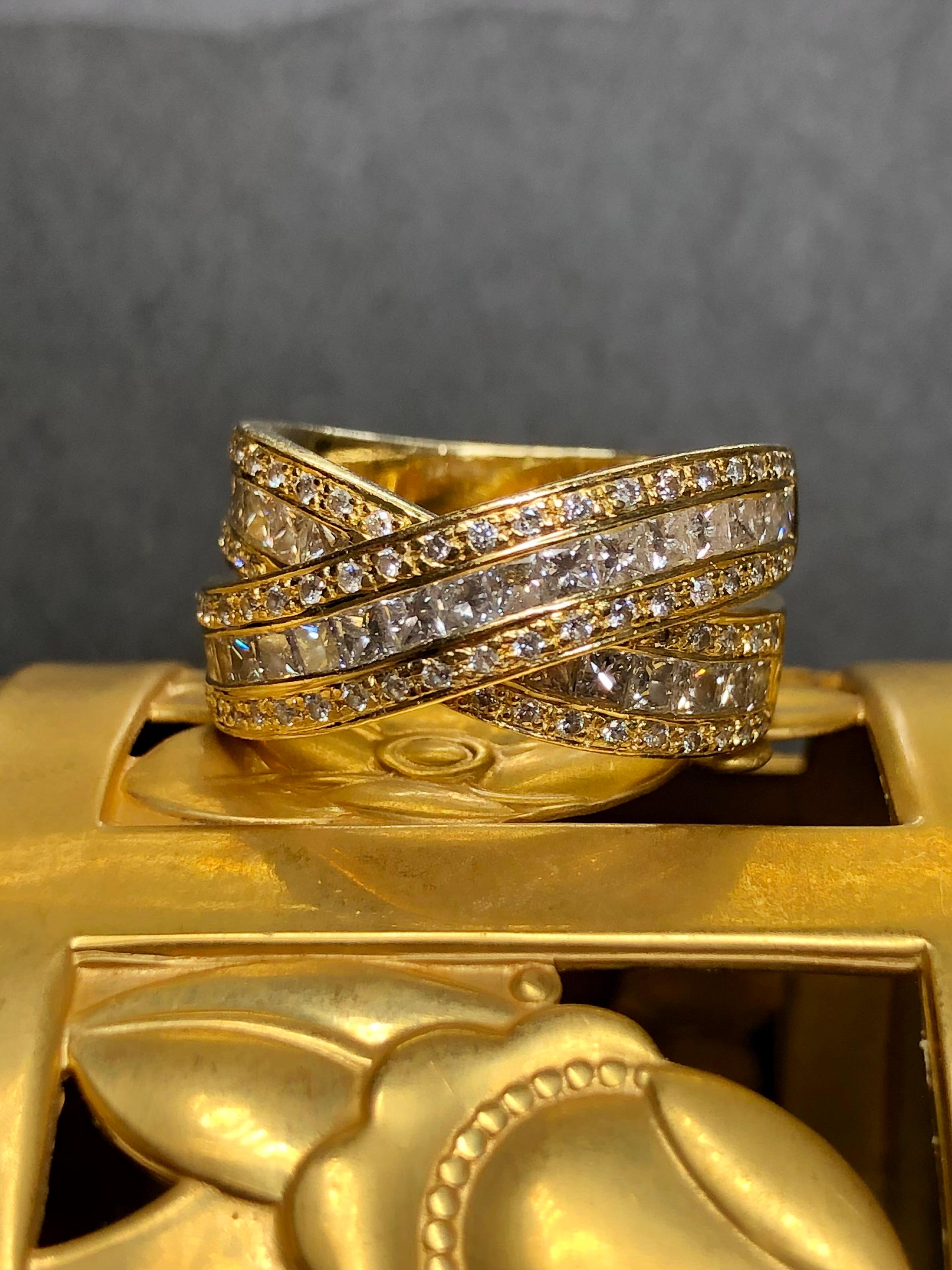 A bold statement ring crafted in 18K yellow gold both channel and prong set with approximately 2.56cttw in G-I color Vs2-Si1 clarity larger princess cut and round diamonds.


Dimensions/Weight:

Ring measures .45” at the top and .30” at the bottom