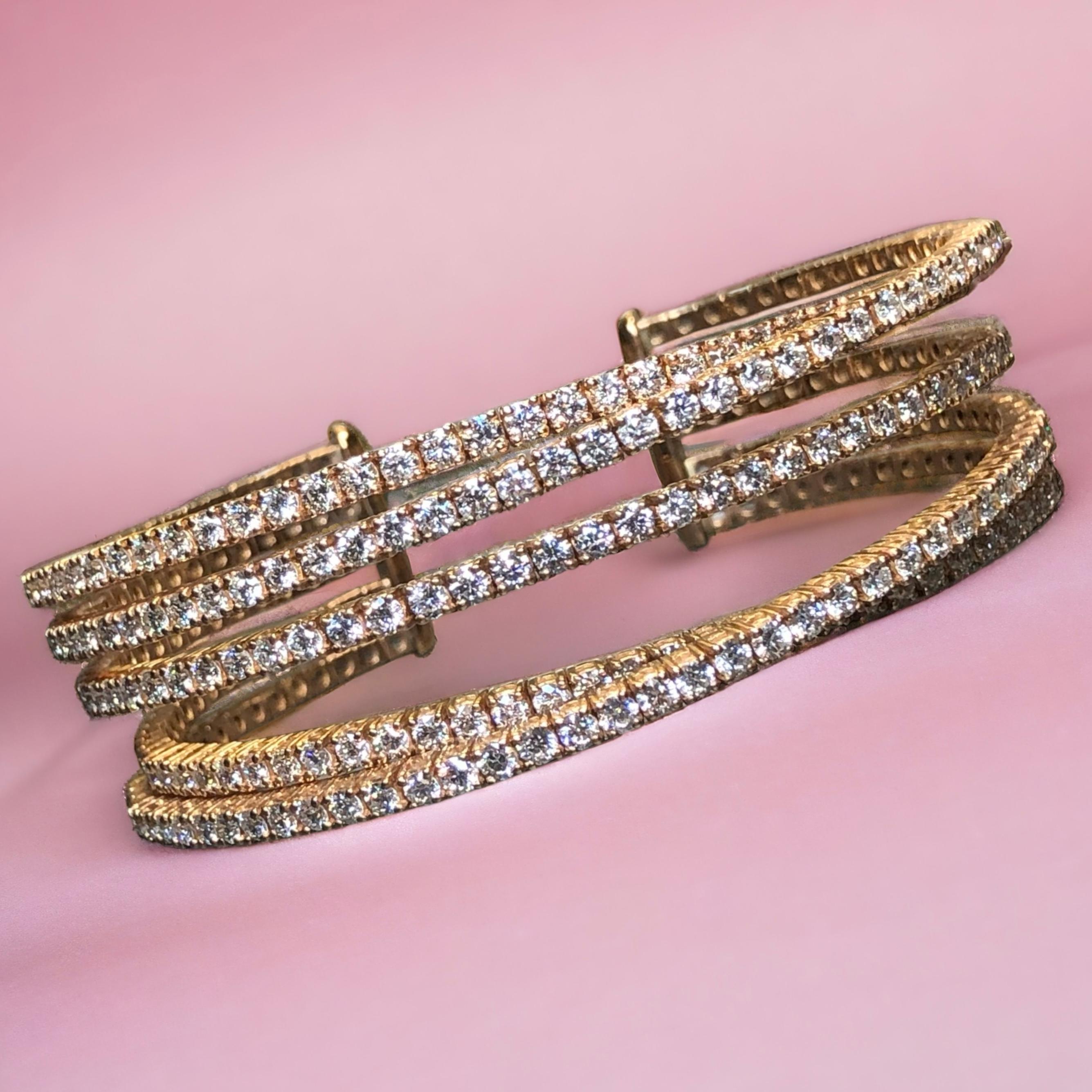 
A stunning cuff bracelet that is absolutely sure to wow! Done in 18K heavy rose gold, this multi-row, overlapping cuff has been exquisitely set with 155 round perfectly matched diamonds weighing approximately 9.30ctw. They average G-H color and