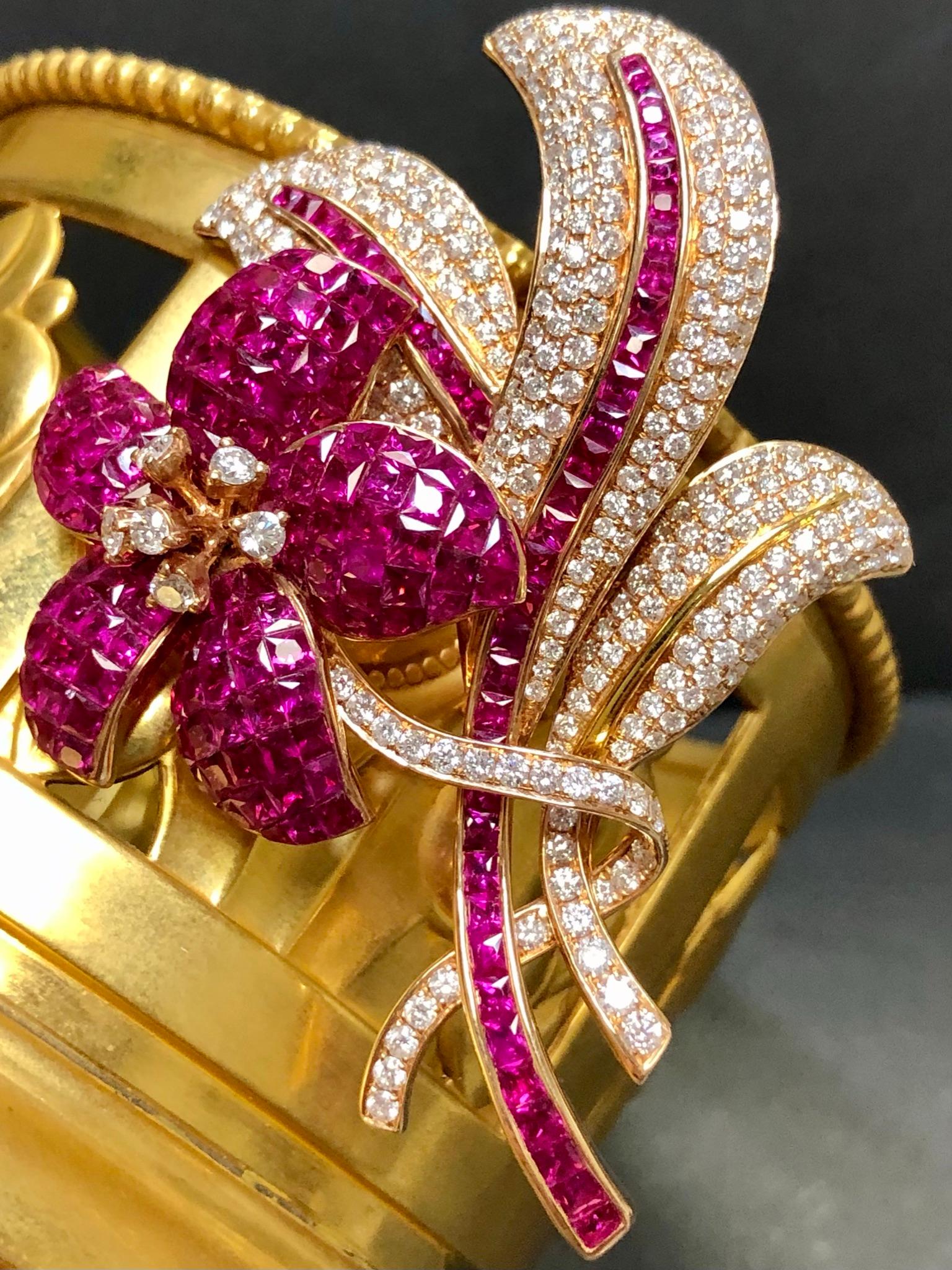 
A beautifully made pin crafted in 18K rose gold set with approximately 5.30cttw in G-I color Si1-i1 clarity round super bright and lively diamonds as well as approximately 15cttw in beautifully bright, natural red rubies. Can be worn as a brooch or