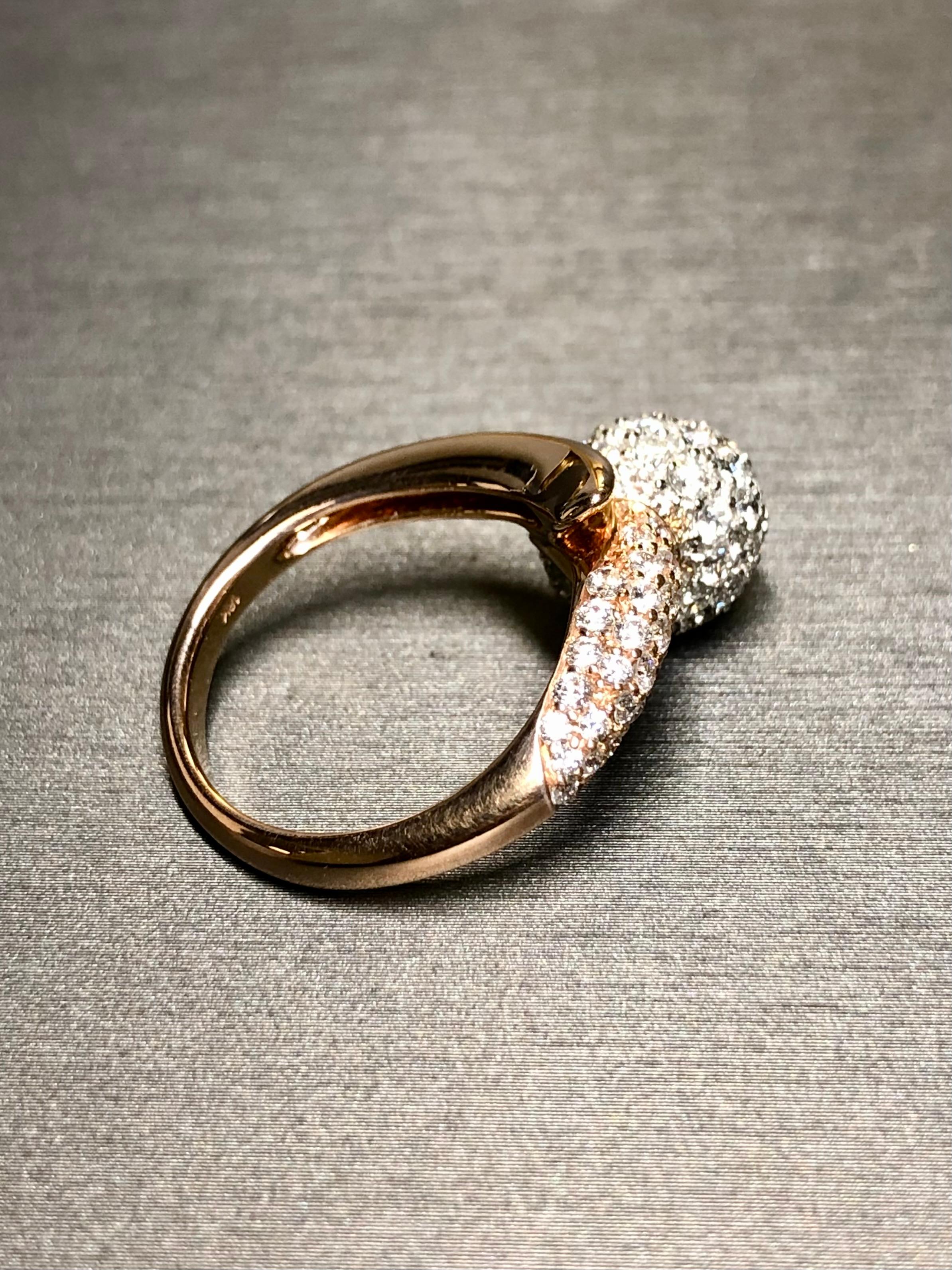 A spectacularly well-made bypass ring done in 18K rose gold with the ball itself being white gold. The diamond setting is impeccable and the overall craftsmanship is exquisite. All diamonds are perfectly matching and range F-G in color and Vs1+ in