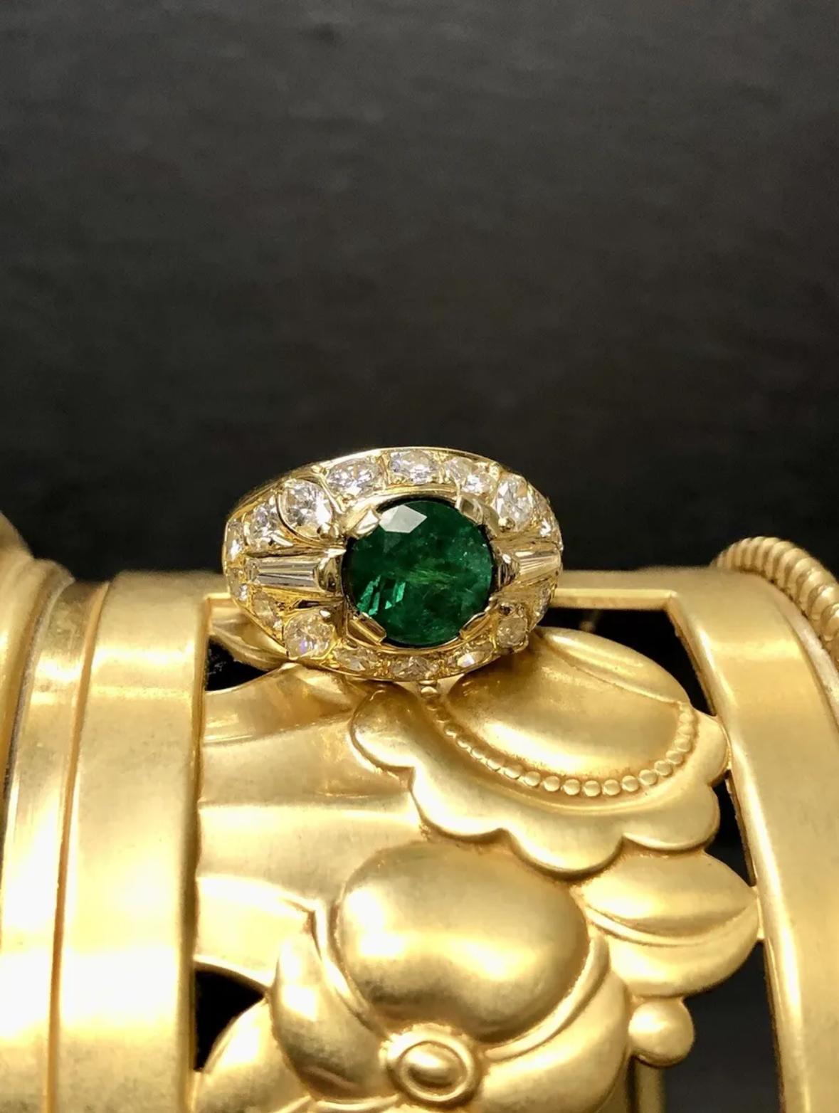 A fabulous ring done in 18K yellow gold containing something of a rarity… a natural round emerald weighing approximately 1.50ct. Zambian in origin, the color is a fabulous deep green and electric and accompanied by a GIA lab report stating origin