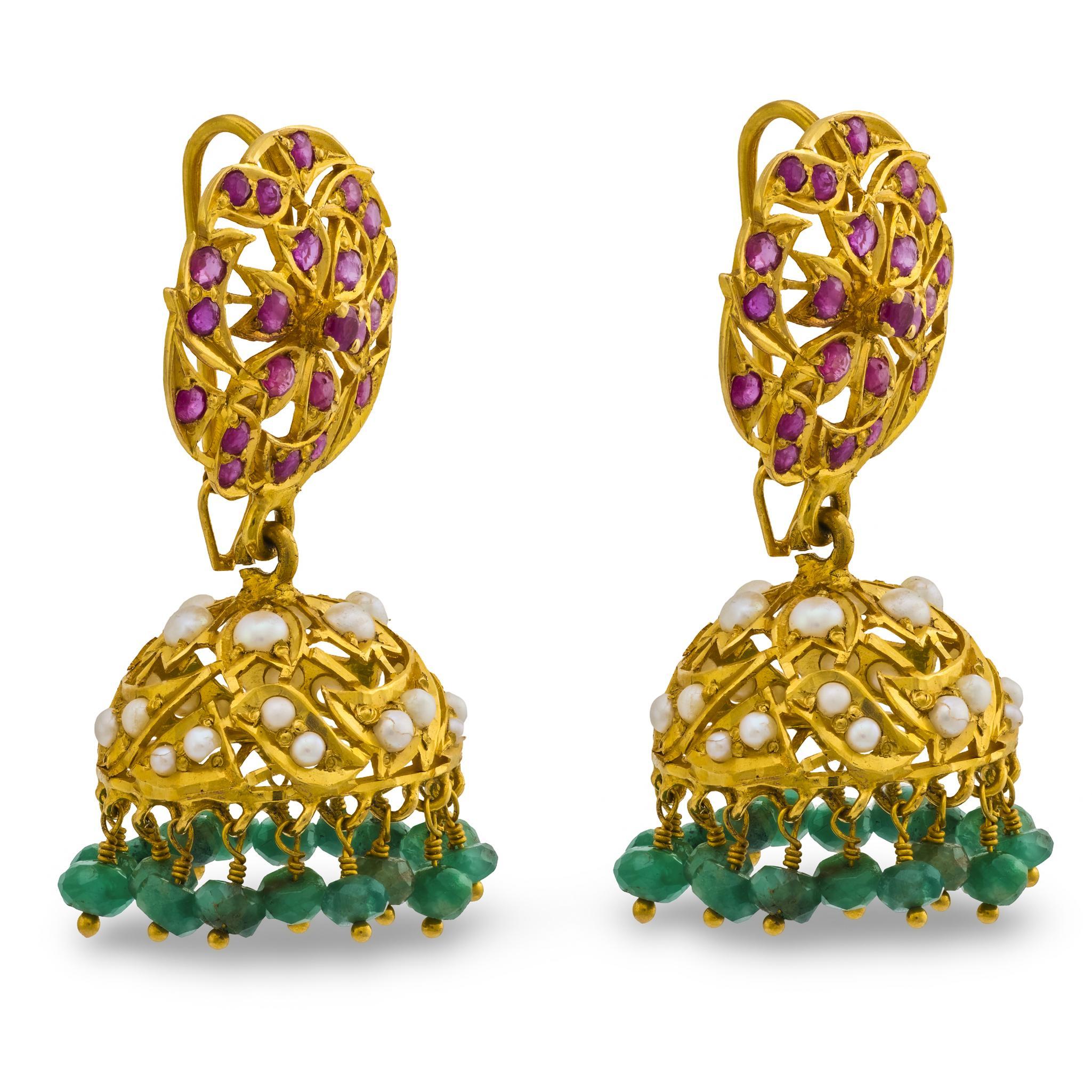 A fantastic and colorful pair of chandelier gemstone earrings! Crafted in 18k vibrant yellow gold, each earring begins with a large circular surmount. The circle-shaped link is comprised of a central floral-motif, which is surrounded by twisting