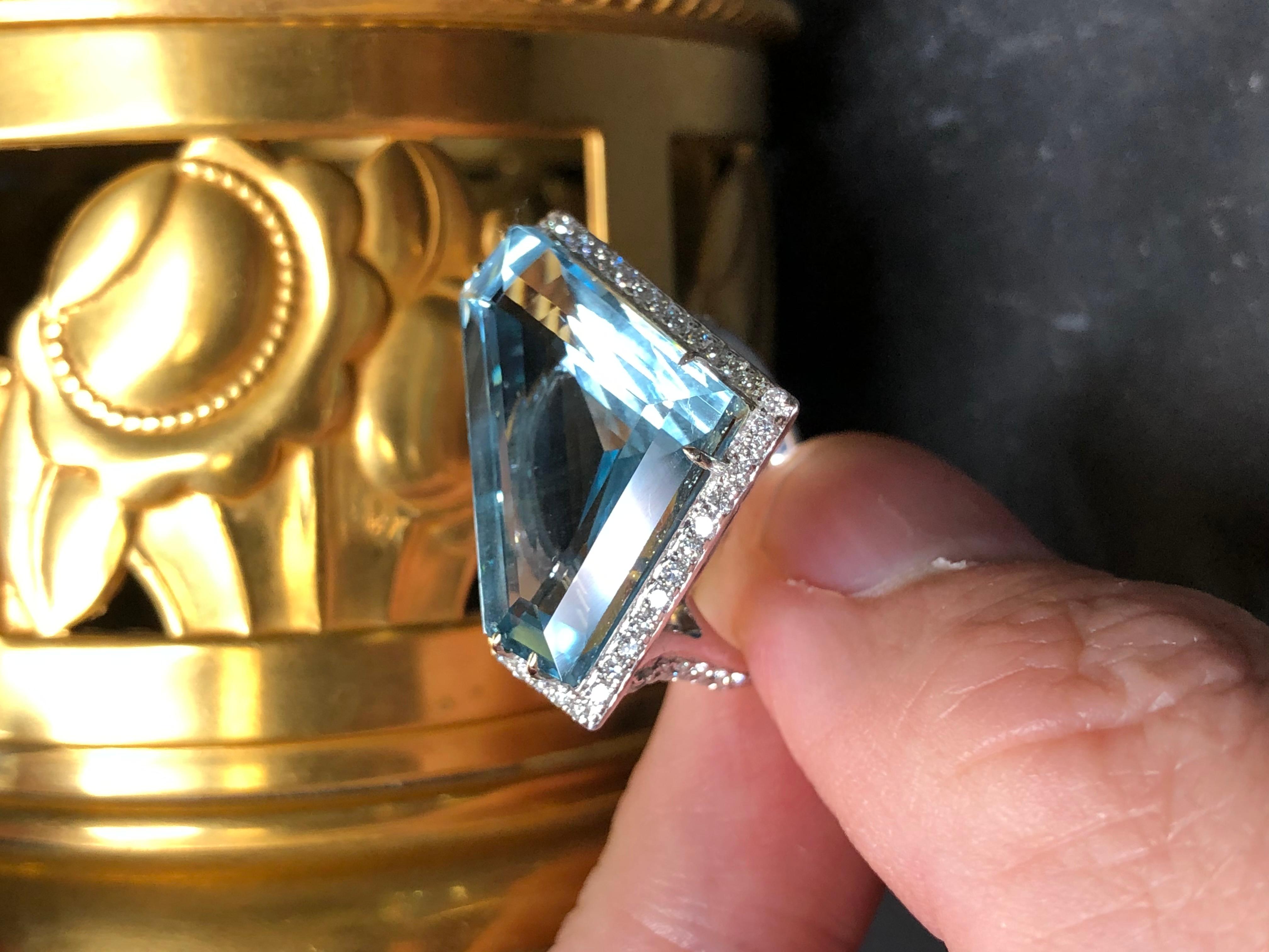 An exquisite ring and very original in its design with great attention to detail. This ring was hand crafted around the uniquely cut aquamarine to produce an absolutely fabulous piece. It is done in 18K white gold and centered by a 17.06ct natural
