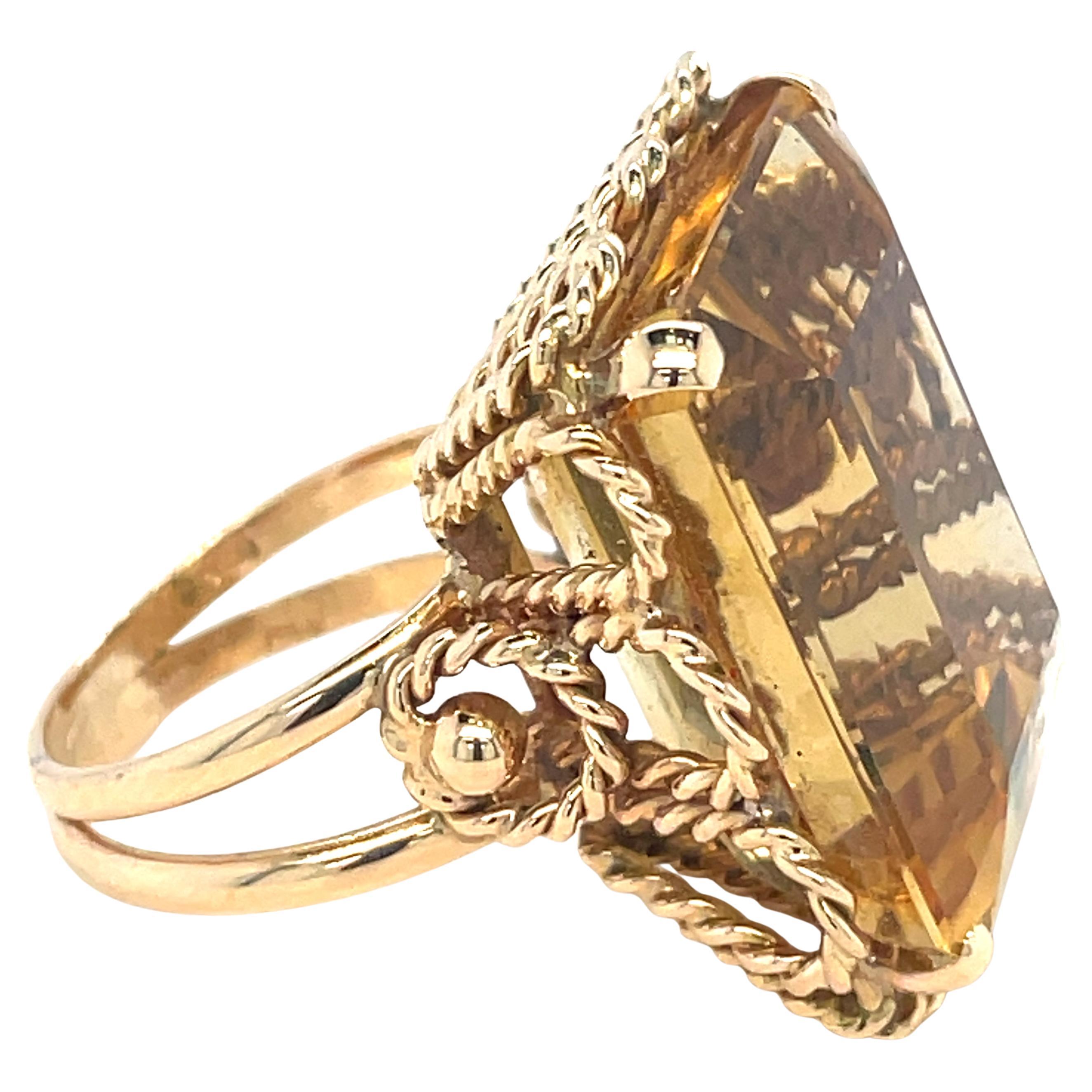 Step back into the glamorous era of retro style with this stunning 18K solid gold cocktail ring. Its centerpiece is a magnificent emerald-cut citrine, boasting a vibrant yellow-gold hue that's simply captivating. The gemstone's impeccable cut and