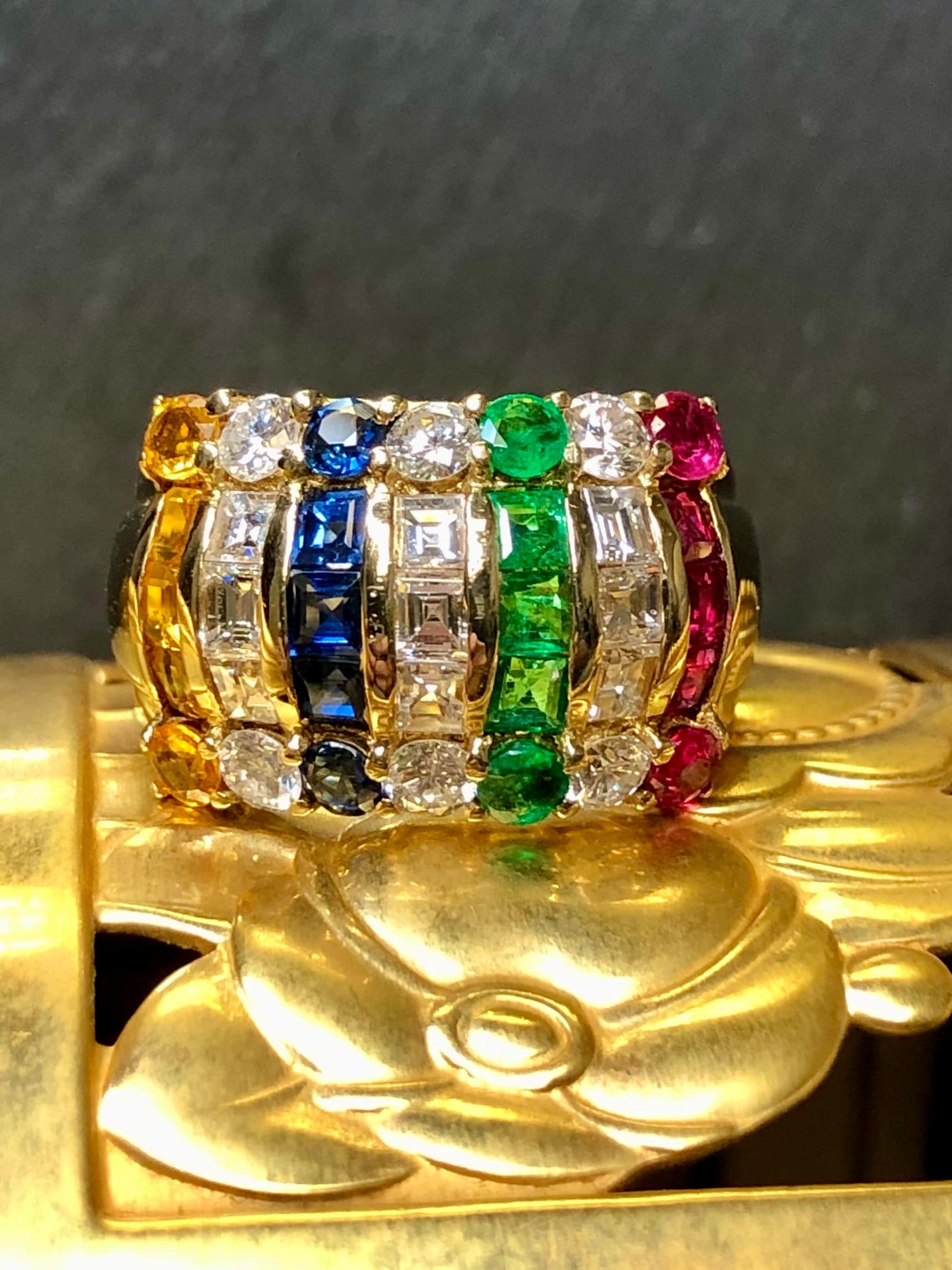 
A gorgeous wide band ring crafted in 18K yellow gold and set with approximately 1.50cttw in G-I color Vs1-2 clarity square baguette and round diamonds as well as .60cttw in rubies, .60cttw in sapphires, .60cttw in orange sapphires and .50cttw in