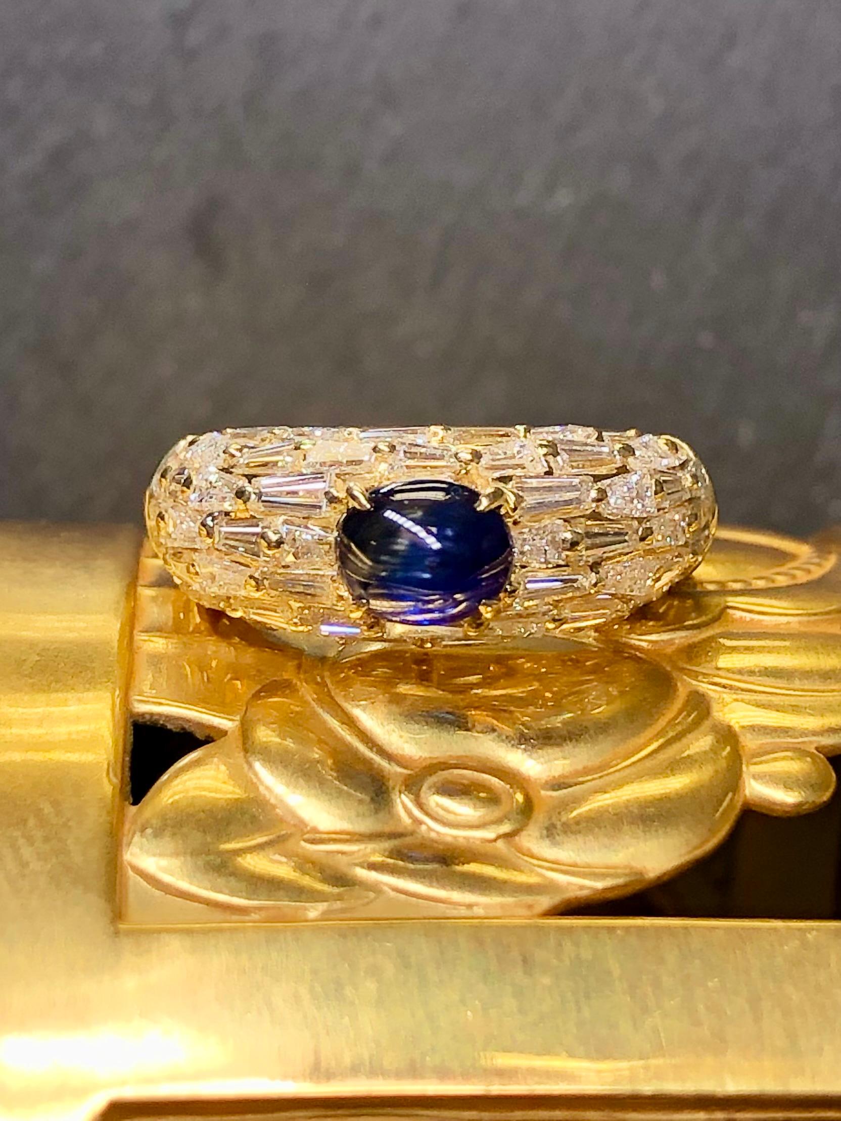 
A bright and lively ring done in 18K yellow gold and set with approximately 2.70cttw in G-H color Vs1-2 clarity tapered baguette diamonds and centered by an approximately 1.20ct royal blue natural cabochon sapphire.


Dimensions/Weight:

Ring