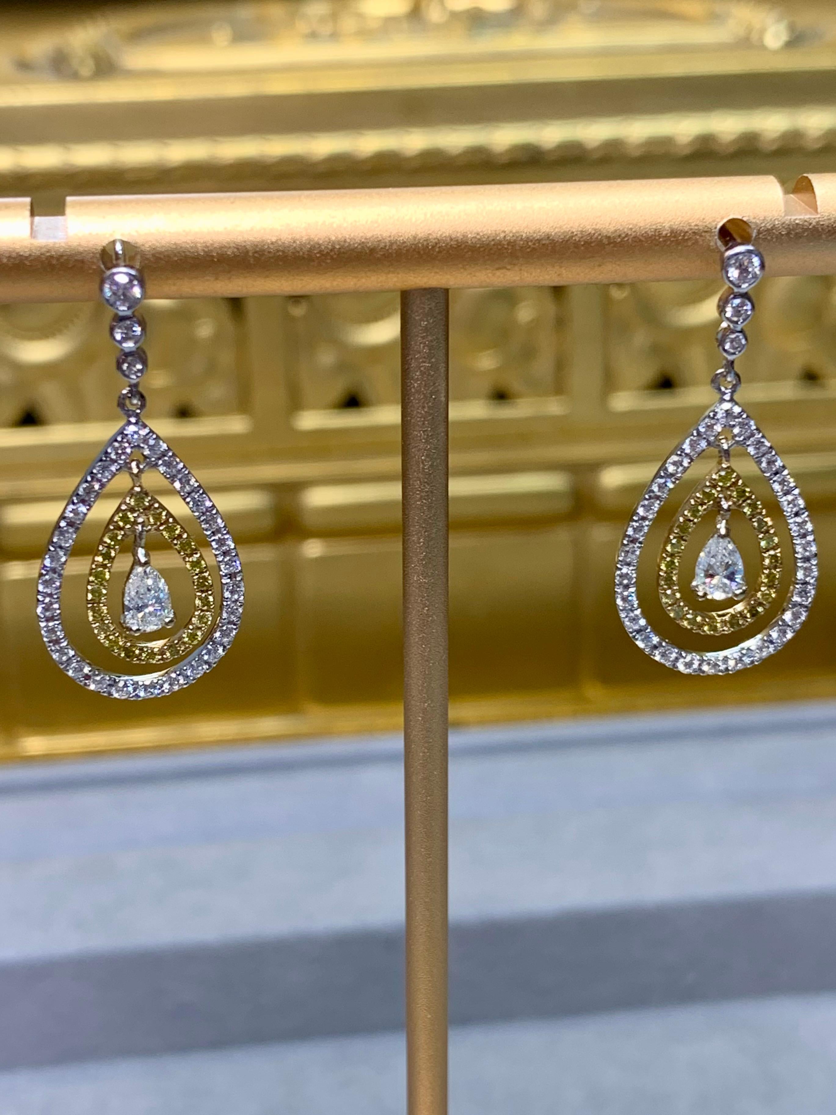 Elegant and refined, these pear-shaped drop earrings are crafted in a sophisticated combination of 18 karat yellow and white gold. Set with a harmonious blend of white and fancy yellow diamonds totaling approximately 1.60 carats, they feature