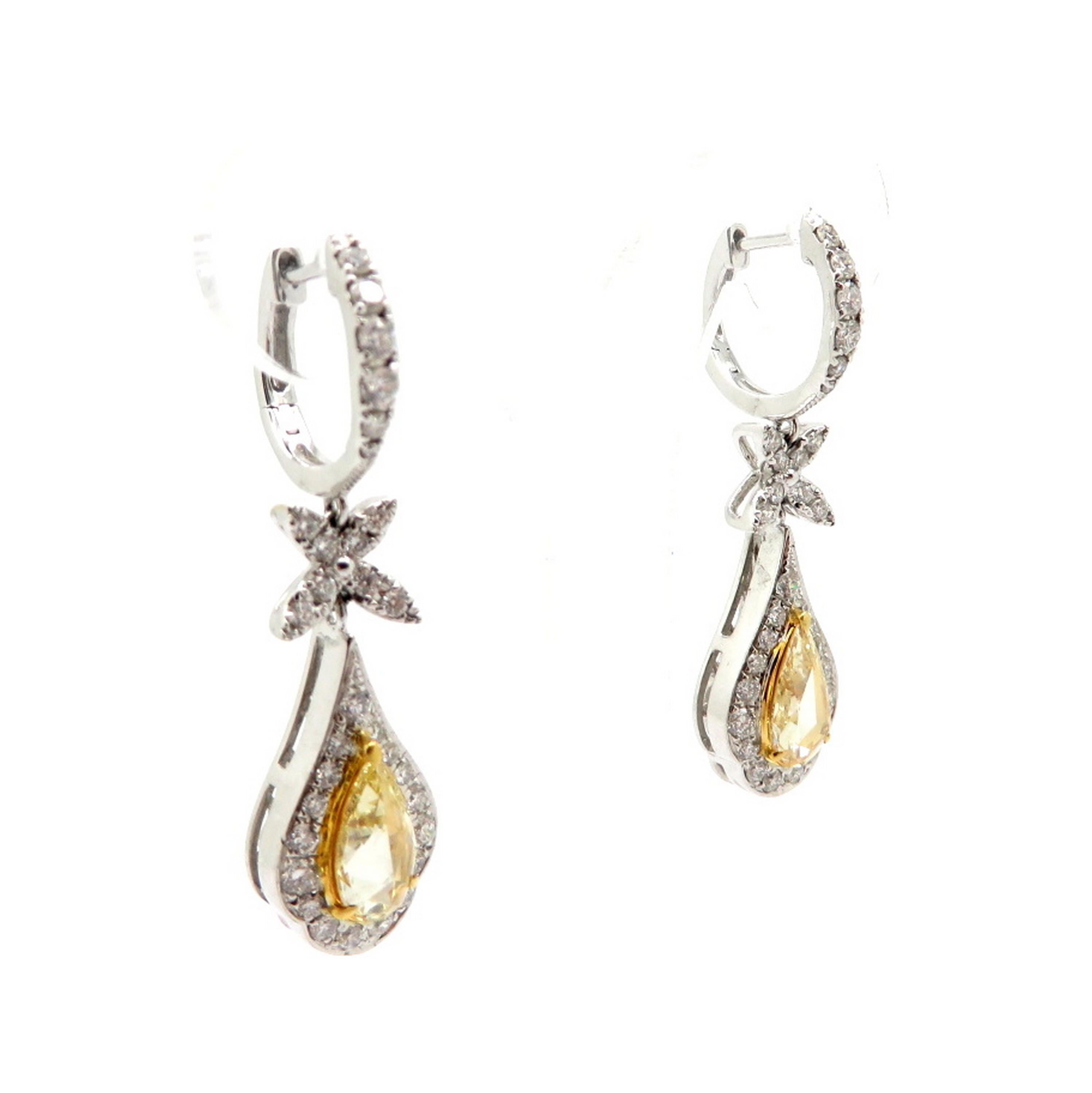 Estate 18K two-tone gold dangle hoop rose cut yellow diamond fashion earrings. Showcasing two fancy yellow rose cut diamonds, each three prong set, having SI1 clarity grade, weighing a combined total of approximately 1.33 carats. Accented with 62