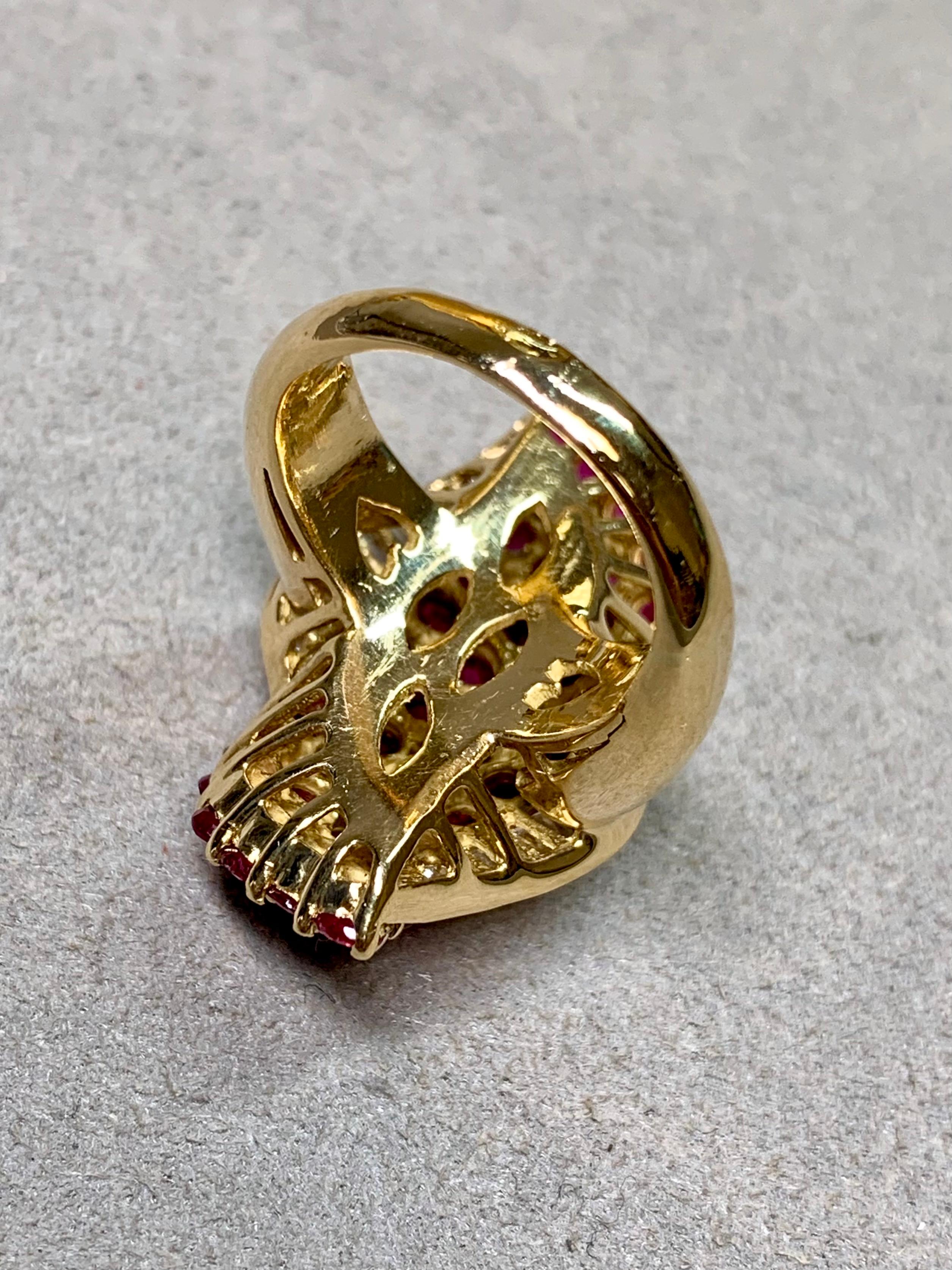 
A freeform elongated cocktail ring crafted in rich 18K yellow gold, showcasing a dramatic display of natural rubies and diamonds. The design is set with 4.65 carats total weight of vivid red round rubies, their vibrant hue intensified by the warmth