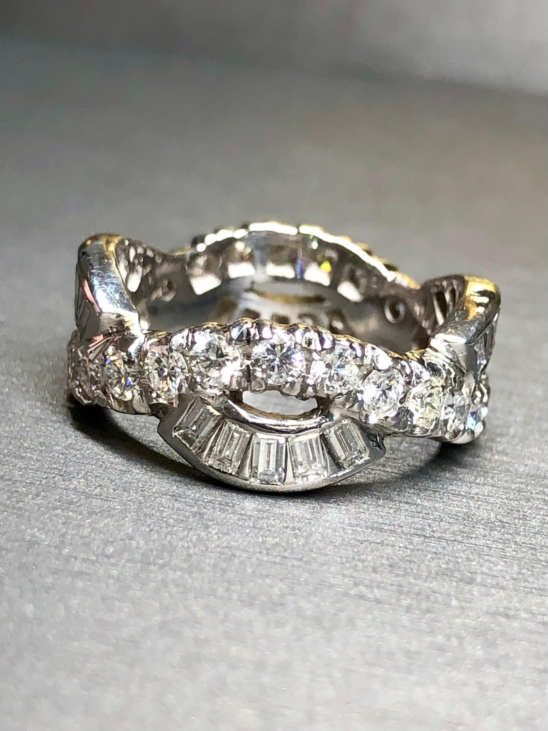 
A very beautifully done eternity band crafted in 18K white gold and both channel and flush set with approximately 3.40cttw in straight baguette and round diamonds all averaging G-H in color and Vs1-2 clarity. The central largest baguettes are about