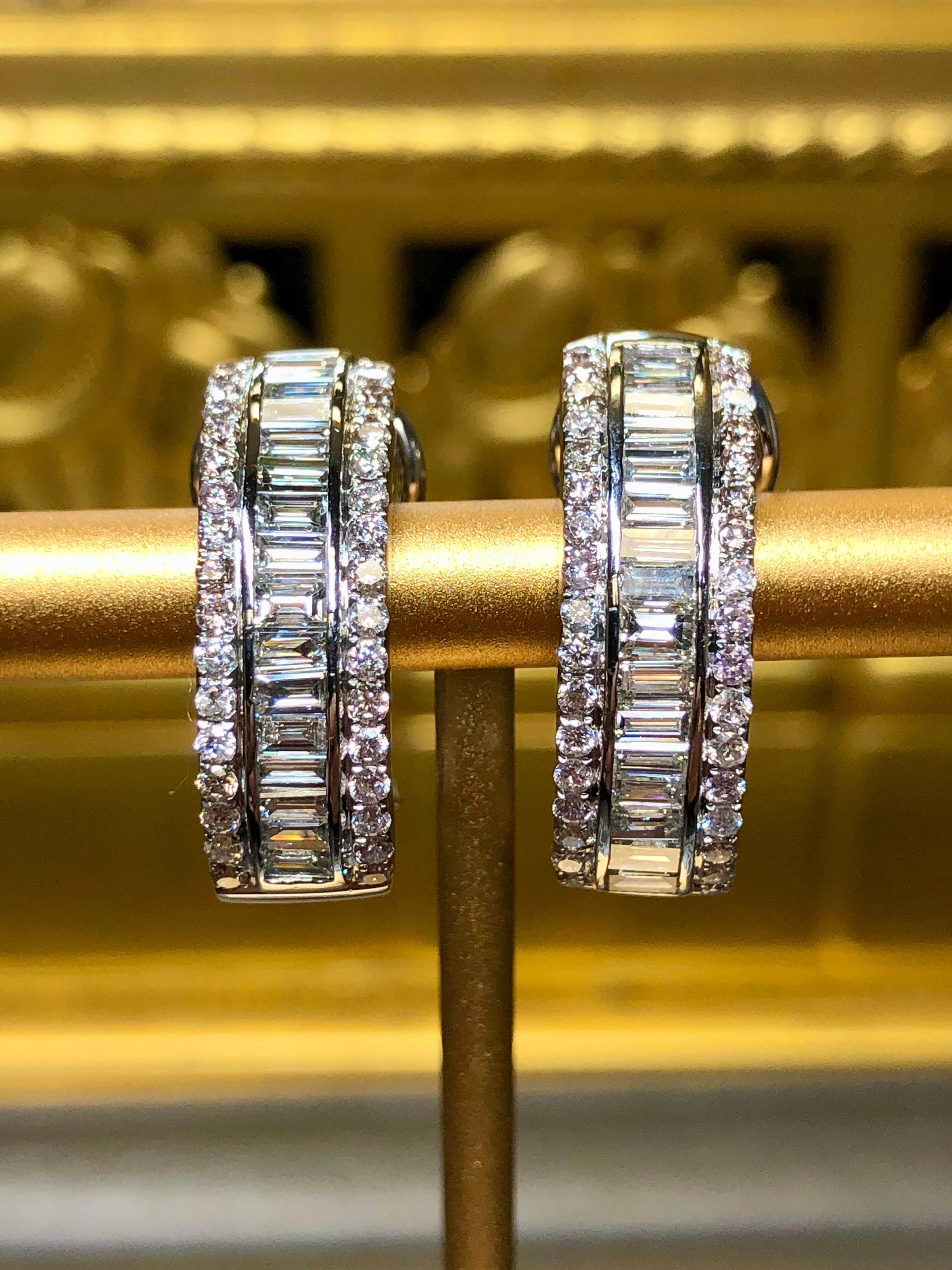 A classic pair of diamond hoop/huggies done in 18K white gold and channel set with approximately 3.26cttw in G-H color Vs1-2 clarity baguette diamonds and Vs2-Si1 clarity round diamonds. These earrings have posts with omega