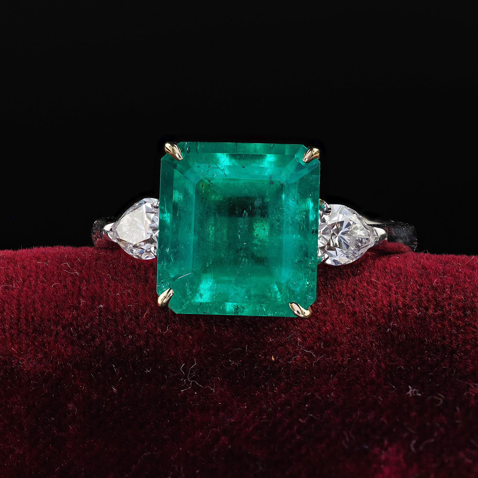 Beautiful Estate 18K White Gold Colombian Emerald and Pear Diamond Engagement Ring - GIA. This beautiful estate Colombian emerald and diamond engagement ring is crafted in 18k white gold and yellow gold head. The ring features a gorgeous glowing