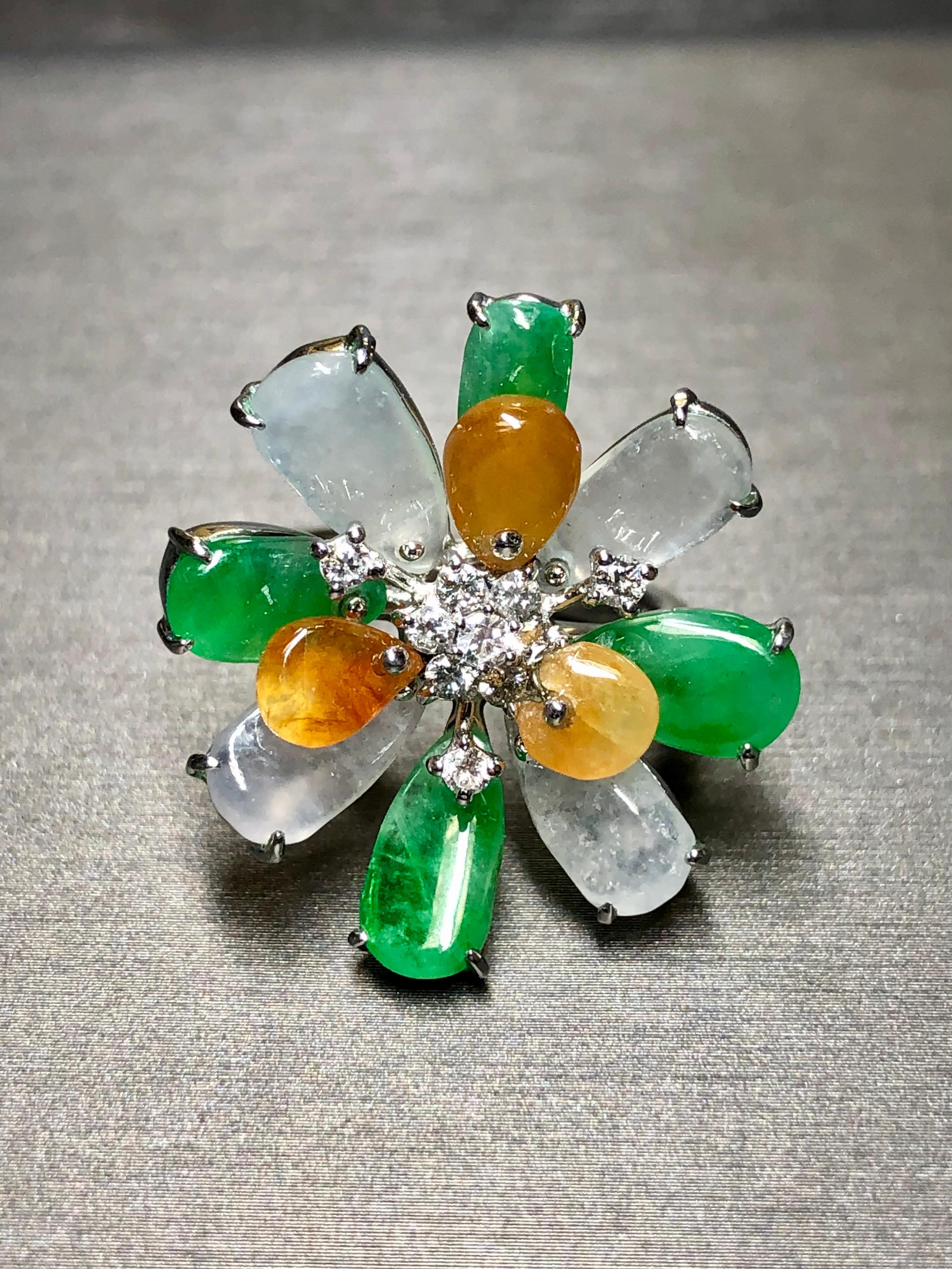 A unique and wonderful piece done in heavy 18K white gold and set with natural pieces of crystal, green and amber Jade centered by approximately .35cttw in H-I Vs2-Si1 clarity diamonds.


Dimensions/Weight:

Ring measures 1 inch in diameter and