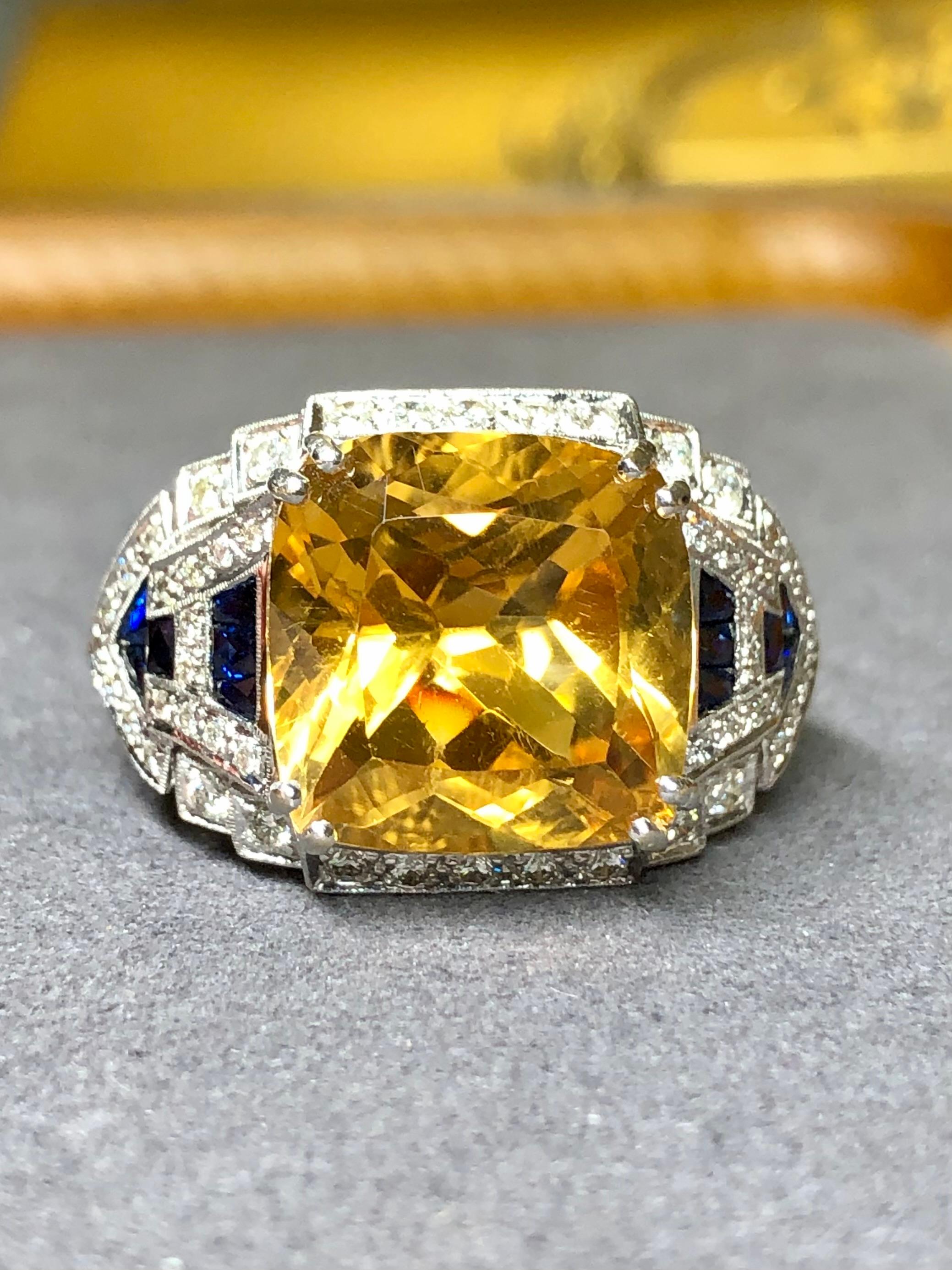 A gorgeous cocktail ring melt made in a very Art Deco style. It is crafted in heavy 18K white gold and centered by an approximately 11.71ct cushion cut natural citrine which is surrounded by approximately .78cttw in G-I color Vs1-2 clarity round
