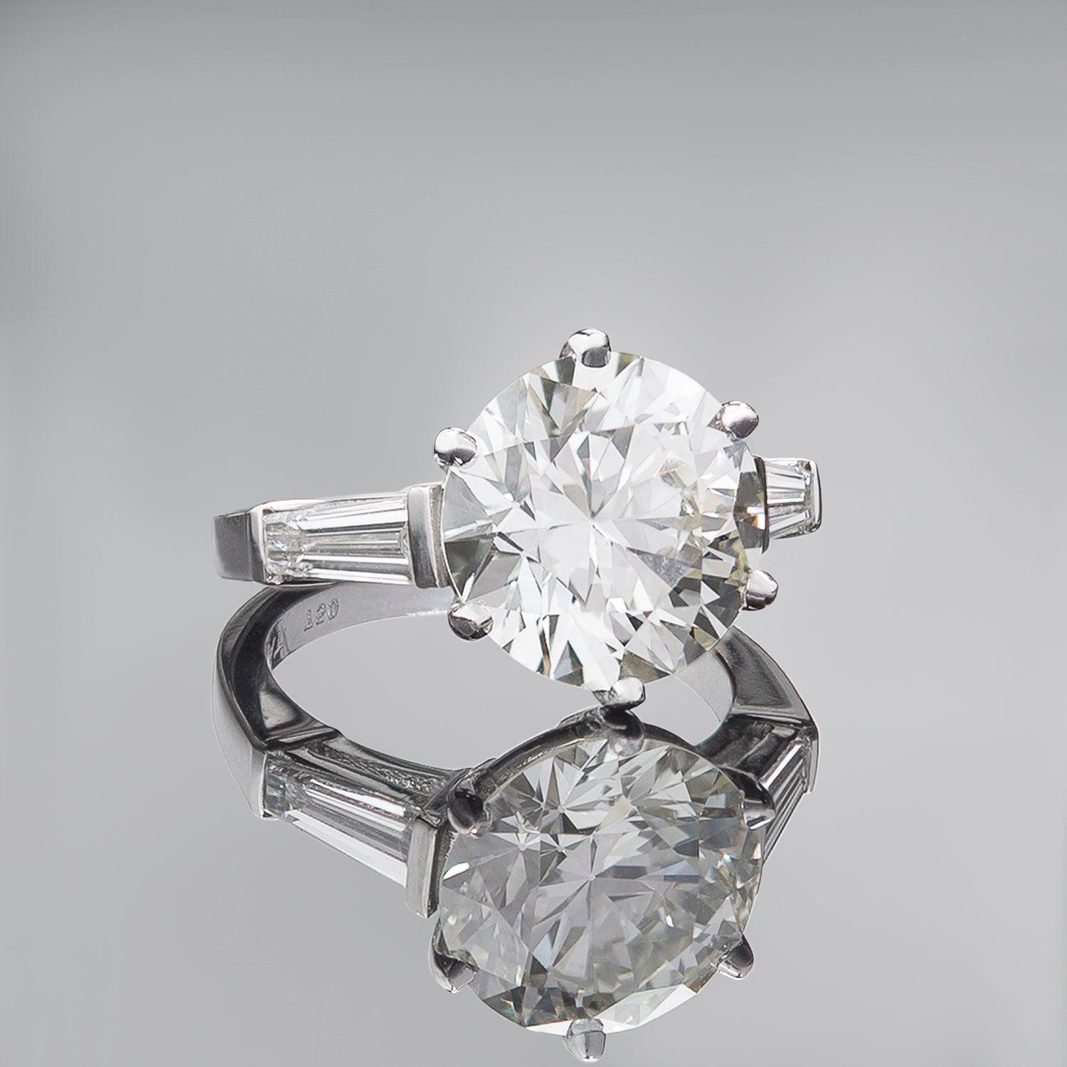 An absolutely jaw-dropping Estate diamond engagement ring! Crafted in 18k white gold, this wonderful piece has a beautiful and classic design featuring a stunning sparkling round brilliant cut diamond at its center. The substantial 6-prong set stone