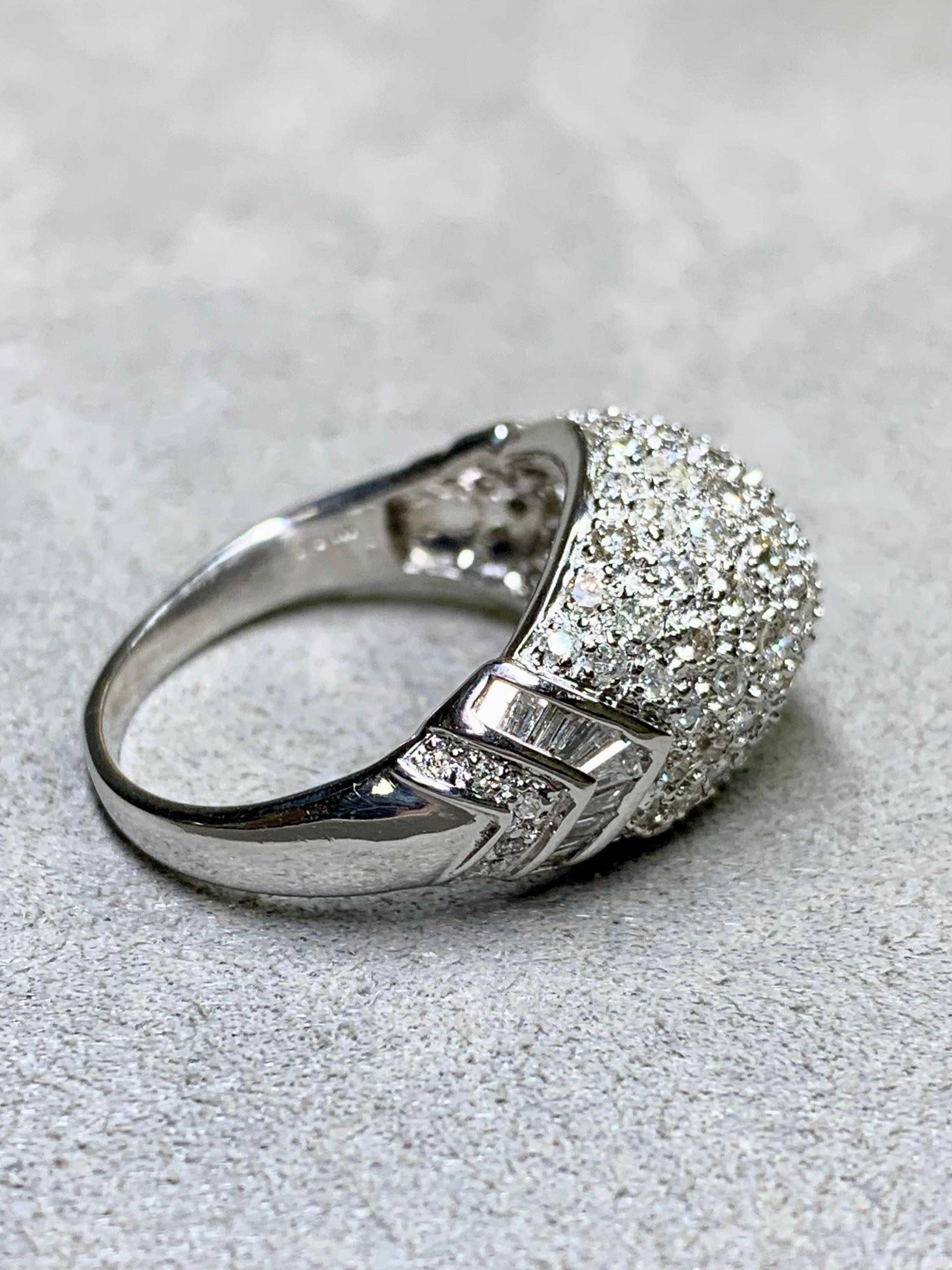 A contemporary ring done in 18K white gold both pavé and channel set with approximately 2.10ctw in H-K color Si1-I1 clarity round and baguette diamonds.


Dimensions/Weight:

This ring measures .50” top to bottom and weighs 6g. Size 7.75