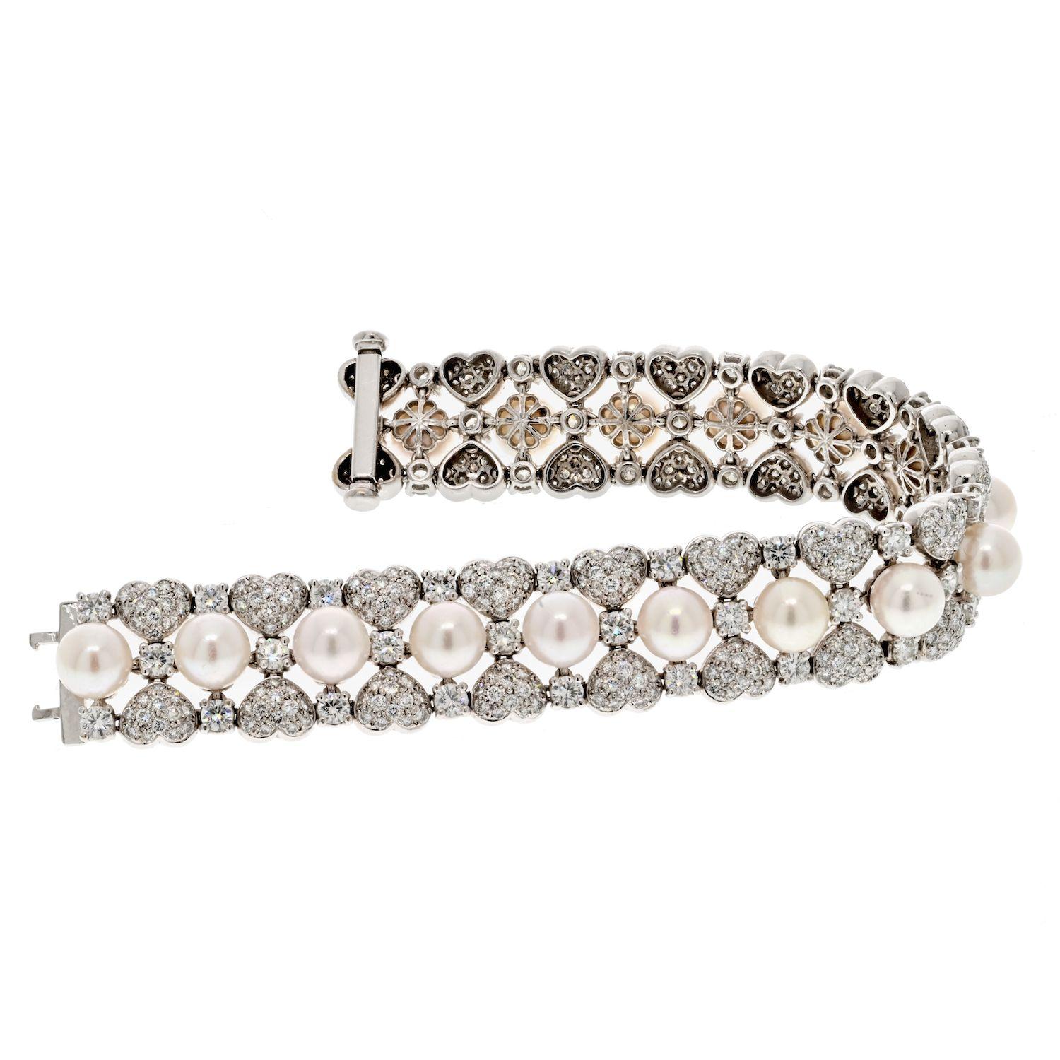 The 18K White Gold 15.00cttw Round Diamond And Pearl One Line Bracelet is a stunning piece that seamlessly combines the elegance of diamonds with the timeless beauty of pearls. Crafted in lustrous 18K white gold, this bracelet features pave set