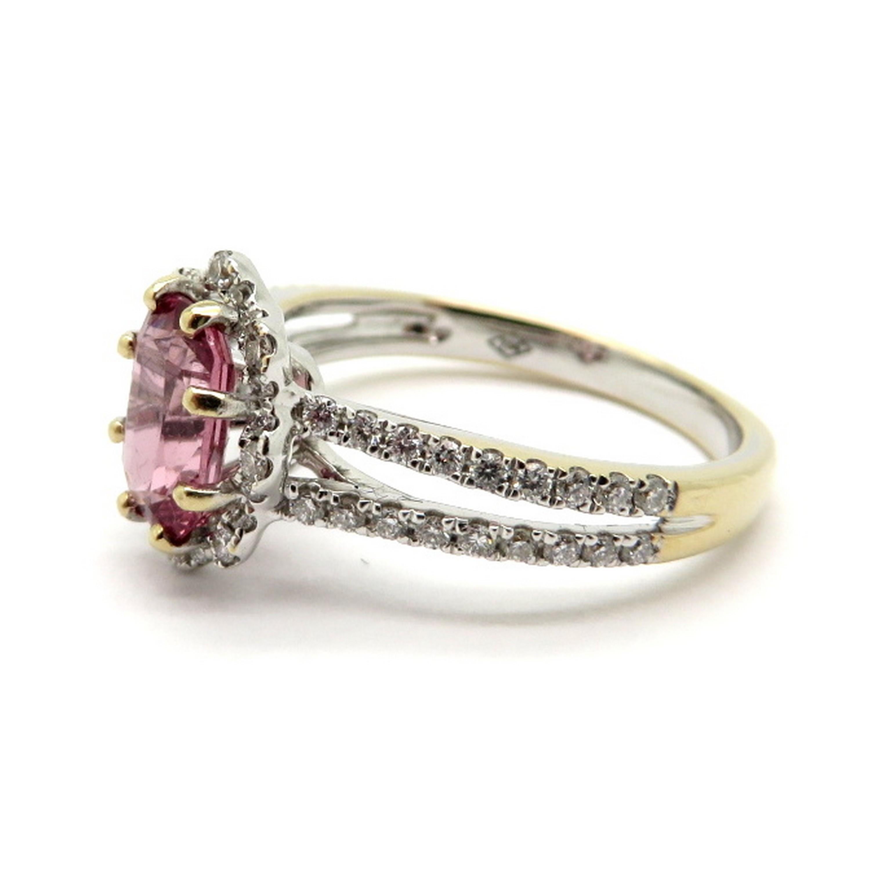 Estate 18K white gold pink spinel and diamond fashion ring. Showcasing one fine quality oval brilliant cut pink spinel, eight prong set, weighing approximately 1.12 carats. Accented with 60 round brilliant cut bead set diamonds weighing a combined
