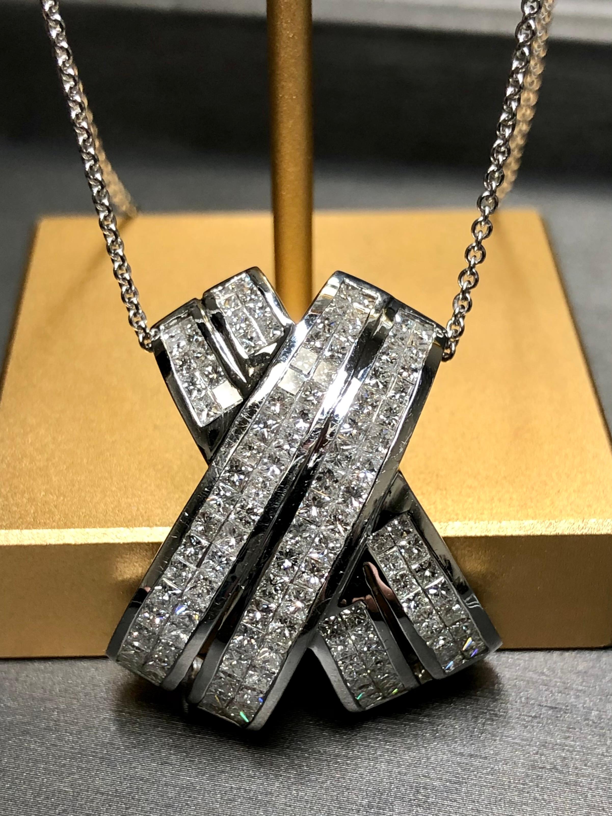 A contemporary yet classic pendant done in 18K white gold set with approximately 4cttw in graduating bright and lively princess cut diamonds ranging G to I in color and Vs1 to Si1 in clarity. A bold and IMPRESSIVE addition to any