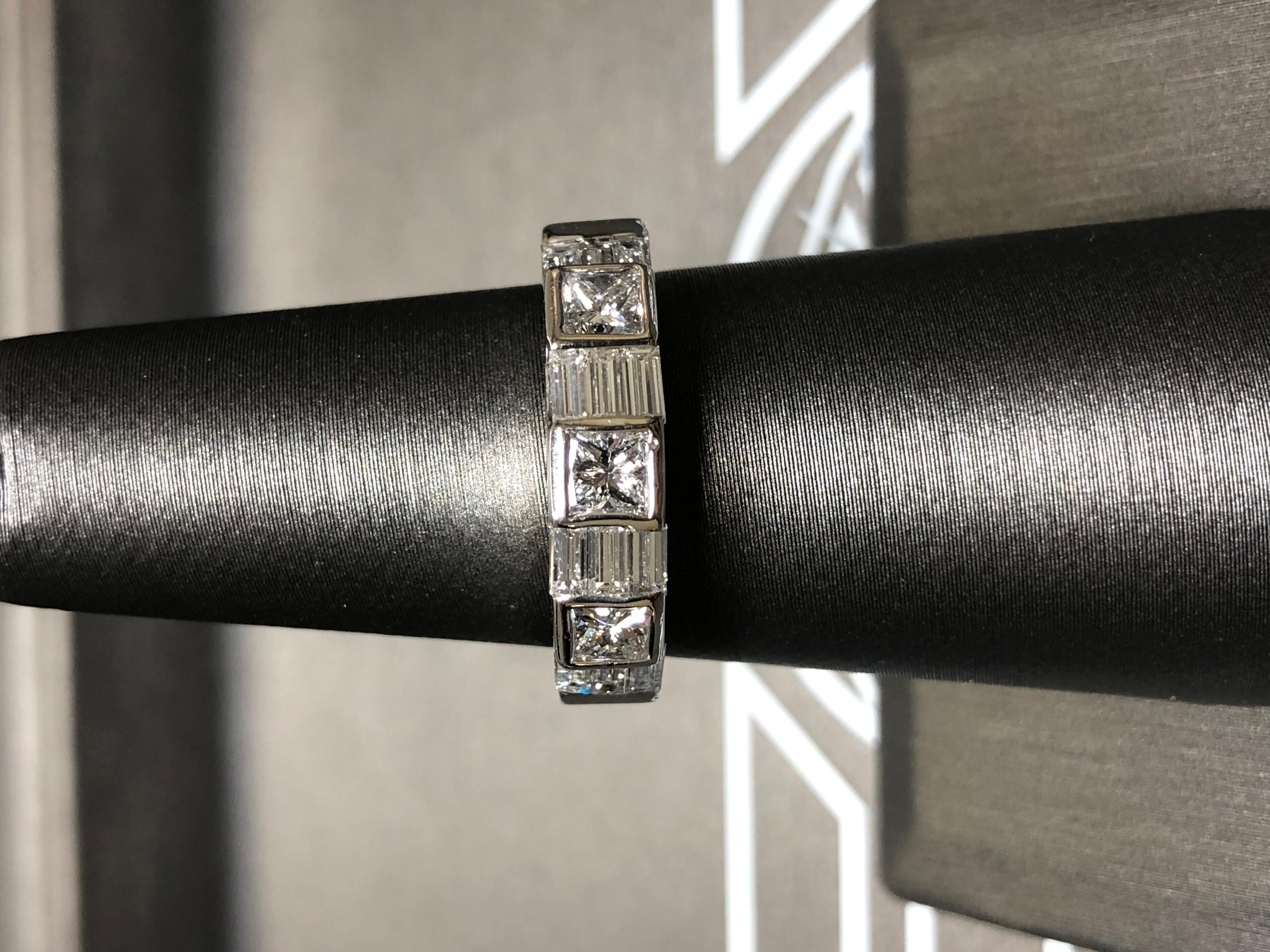 
A striking estate band crafted in 18K white gold tension and bezel set with approximately 1.47cttw in G-H color Vs1 clarity princess and baguette cut diamonds (princess cuts average .25ct each stone).


Dimensions/Weight:

Ring measures .20” wide