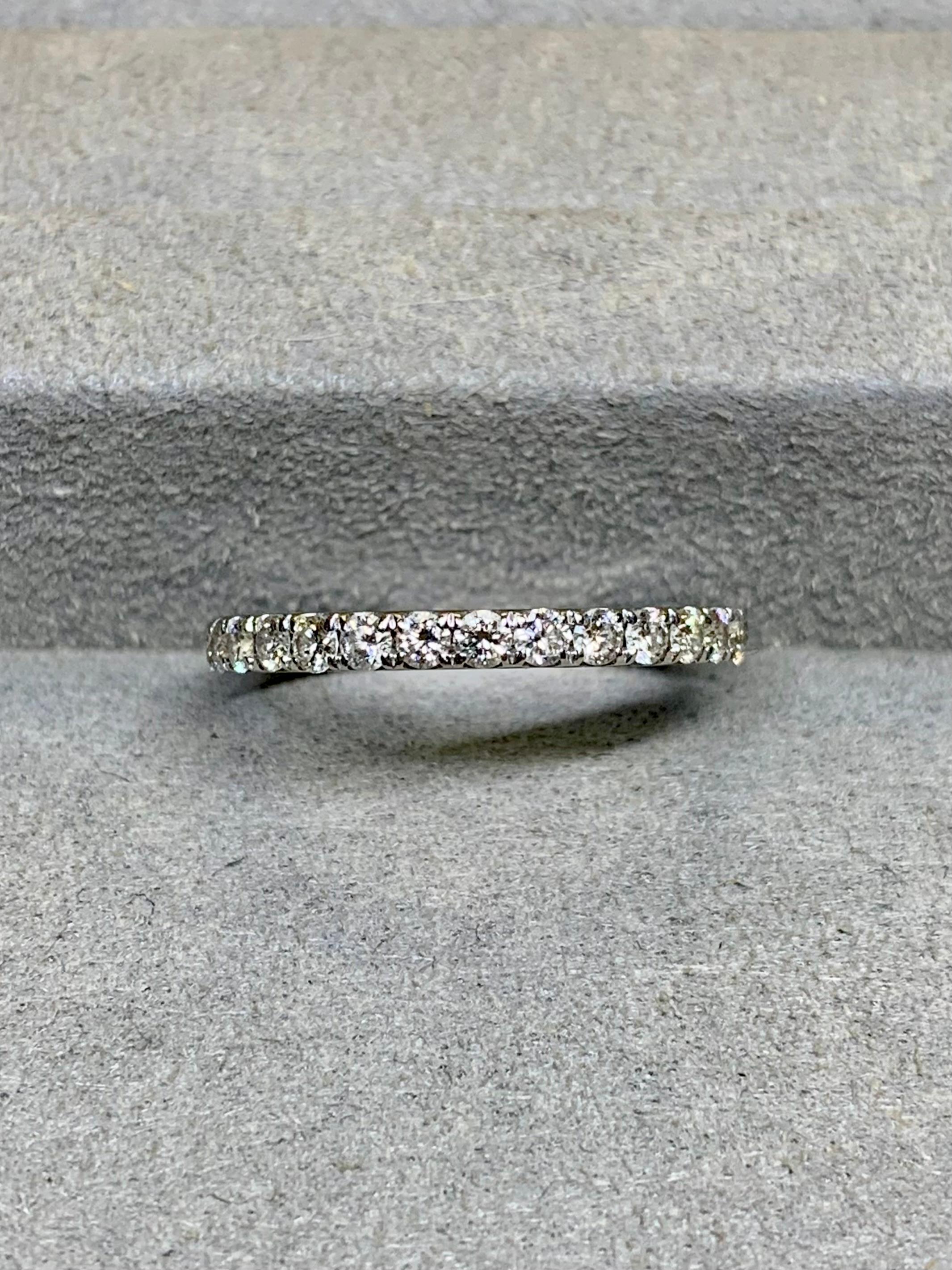 Traditional eternity band crafted in 18K white gold and 4-prong set with 30 round, full cut natural diamonds averaging G-H in color and Vs1-2 in clarity. Stamped “MILANJ” inside the band.


Dimensions/Weight:

Ring measures 2.15mm wide and weighs