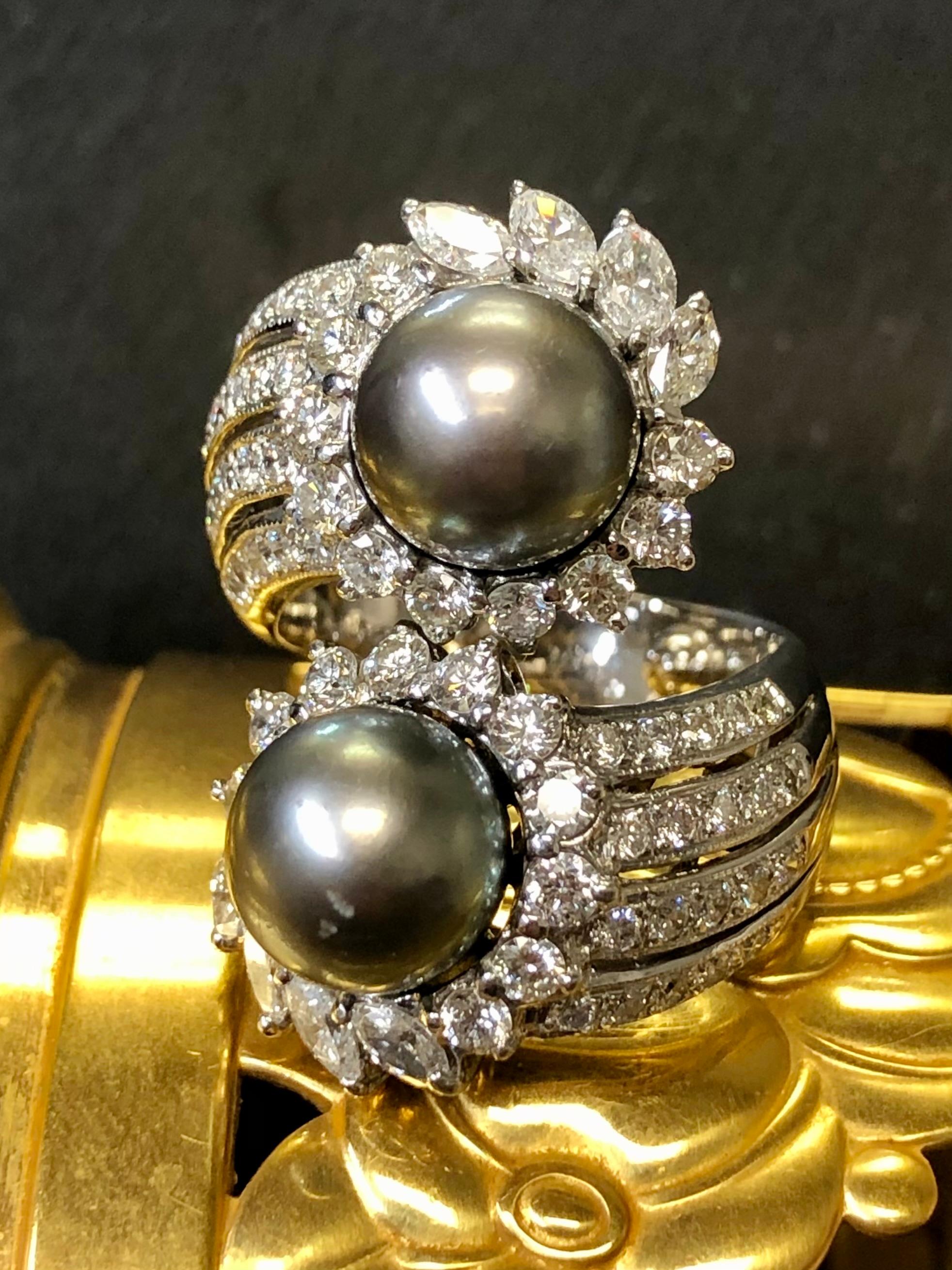 
A stunningly impressive large bypass ring done in 18K white gold and set with approximately 3cttw in G-I color Vs1-2 clarity marquise and round diamonds diamonds with each section centered by 10mm Tahitian pearls. Such a look and such a presence on