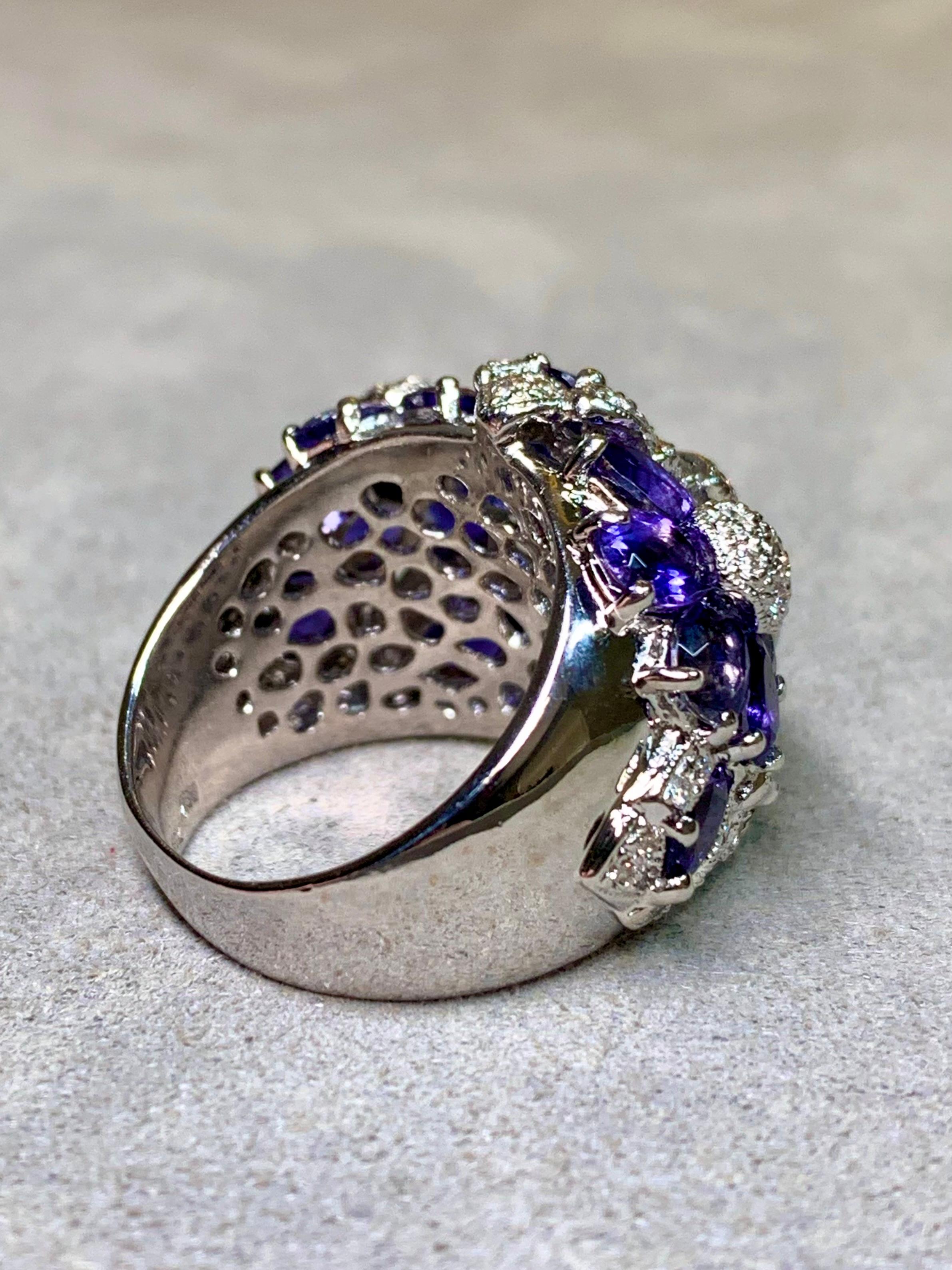 
A bold and sculptural estate cocktail ring with a strikingly contemporary floral design, this piece is crafted in rich 18 karat white gold and set with vividly saturated oval-cut natural tanzanites totaling approximately 6.00 carats. Accented by