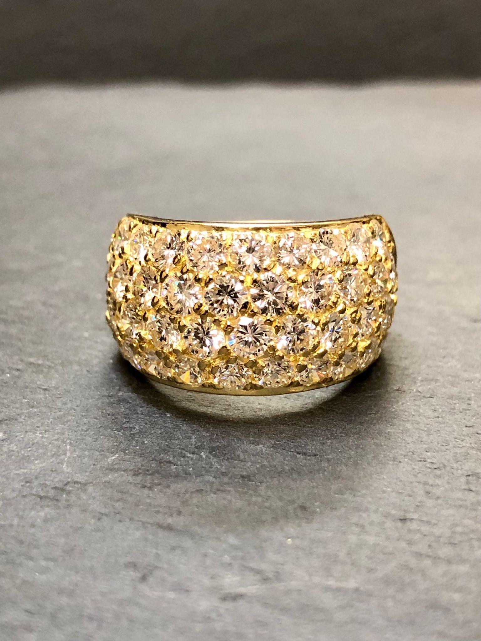 An extremely well done ring made in 18K yellow gold and set with perfectly matched, collection quality E-G color Vs1 clarity large diamonds with a total approximate weight of 4.65cttw. Notice the perfect azuring on the back as well. An incredible