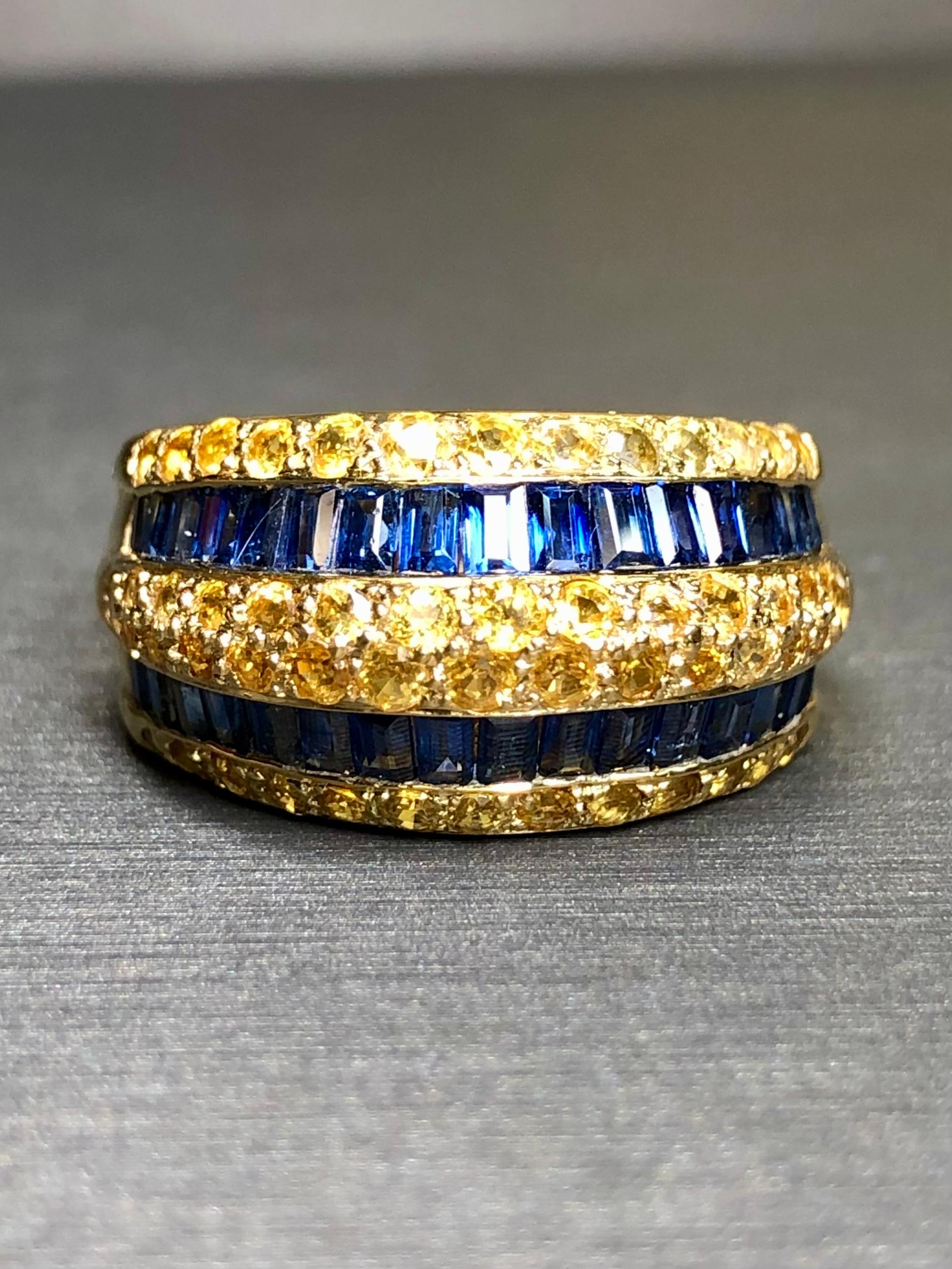 A contemporary, elegant wide band cocktail ring done in 18K yellow gold and channel set with 1.64cttw in blue sapphires as well as pavé set with 2.17cttw in yellow sapphires.


Dimensions/Weight:

Ring measures .47” top to bottom and weighs 9.7g.