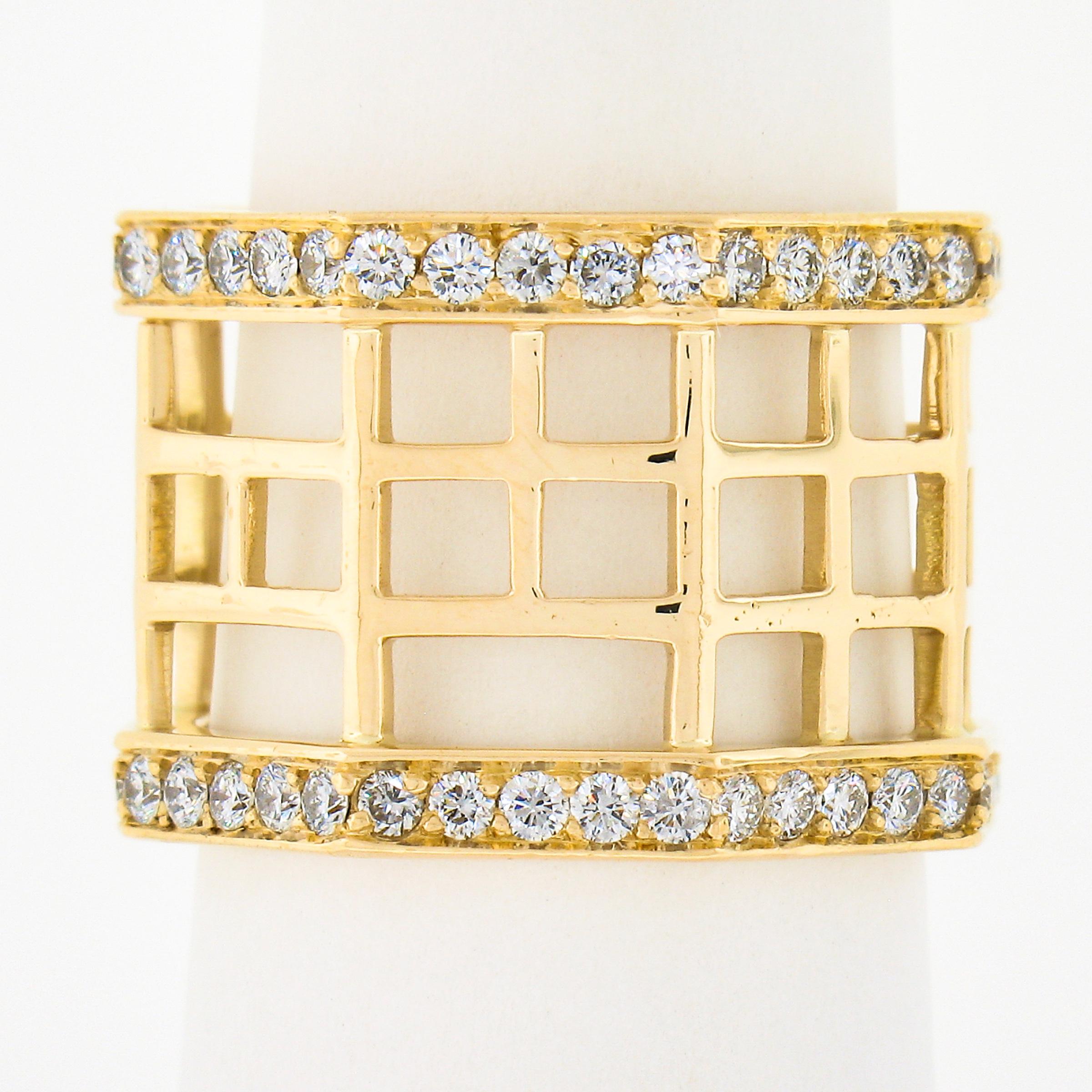 This gorgeous wide band ring is crafted in solid 18k yellow gold and features  beautiful open geometric design throughout the center section while he sides are covered with round brilliant cut diamonds neatly pave set, totaling approximately 1.40