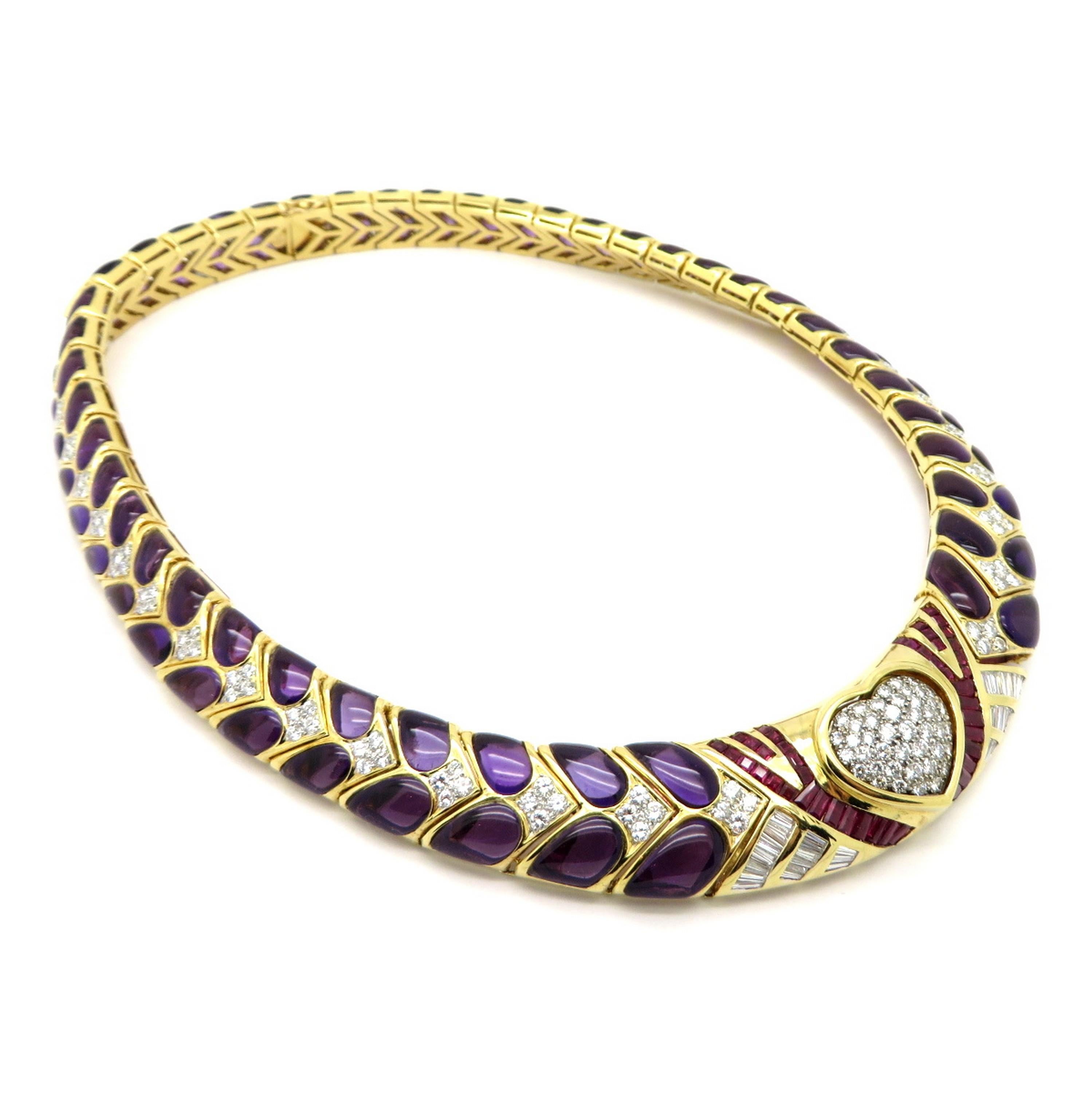 Estate 18K yellow gold 200 carat amethyst, ruby and diamond designer Endless Knot necklace. Showcasing 44 baguette and square cut fine quality rubies weighing a total of 3.00 carats. Featuring a diamond heart containing numerous pave set round