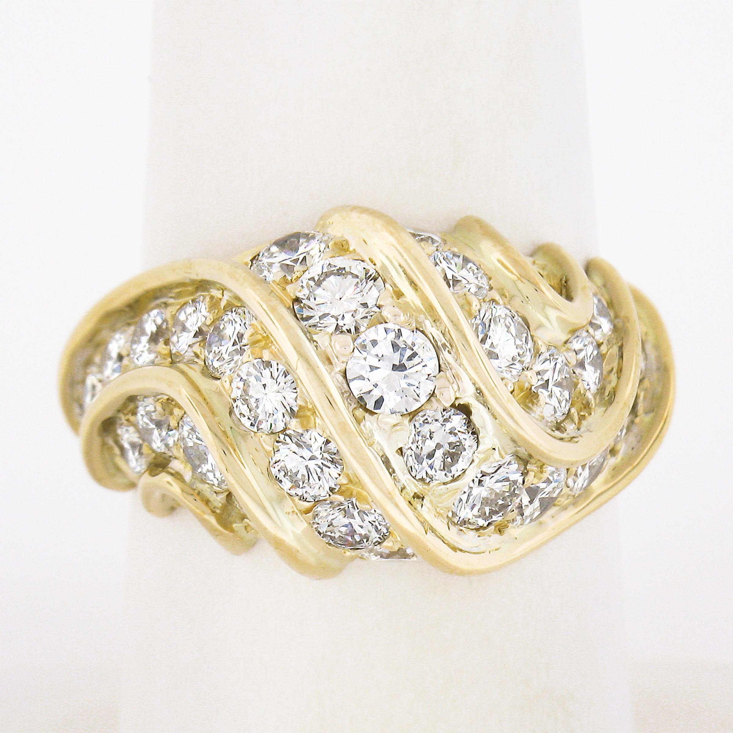 This truly magnificent bombe ring is crafted in solid 18k gold and features approximately 3.35 carats of large and fiery round brilliant cut diamonds. The diamonds are carefully pave set in between raised gold channels that scroll and swirl