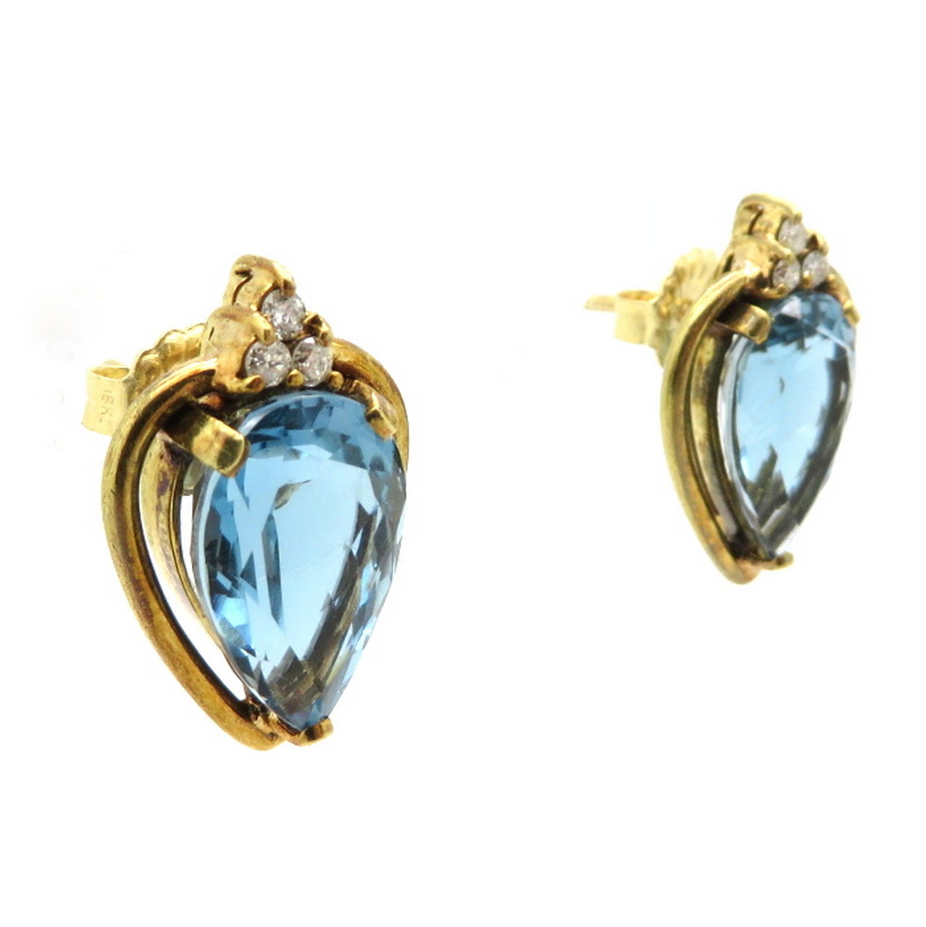 Estate 18K yellow gold 8.00 carat pear shaped blue topaz and diamond fashion earrings. Showcasing two fine quality pear shaped blue topaz gemstones, each three prong set, weighing a total of 8.00 carats. Accented with six prong set round brilliant