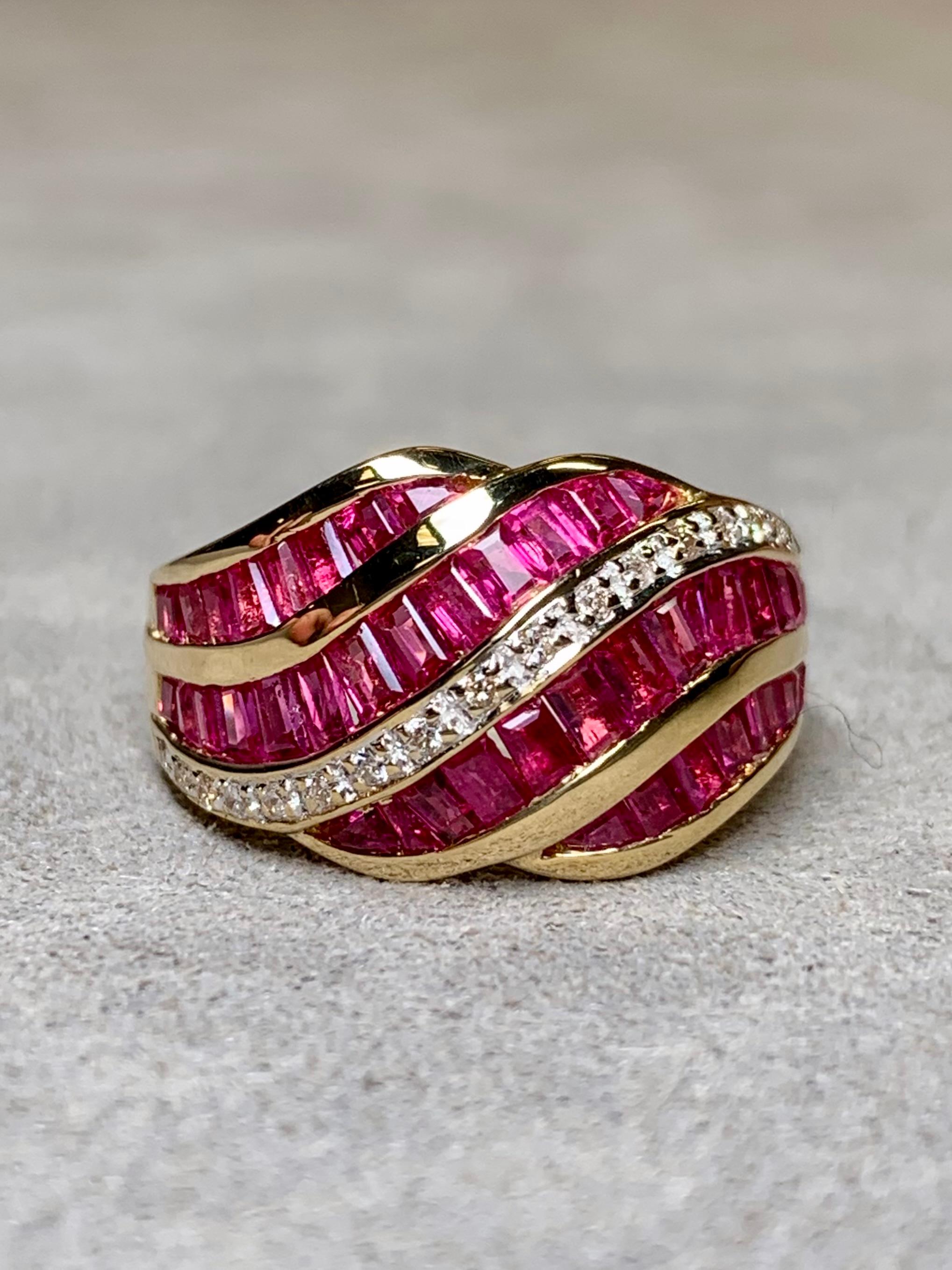 
A lovely wide band cocktail ring done in 18K yellow gold and channel set with natural bright red rubies with a total approximate weight of 1.80ctw as well as .18ctw in H-J color Vs2-Si1 clarity round diamonds.


Dimensions/Weight:

Ring measures