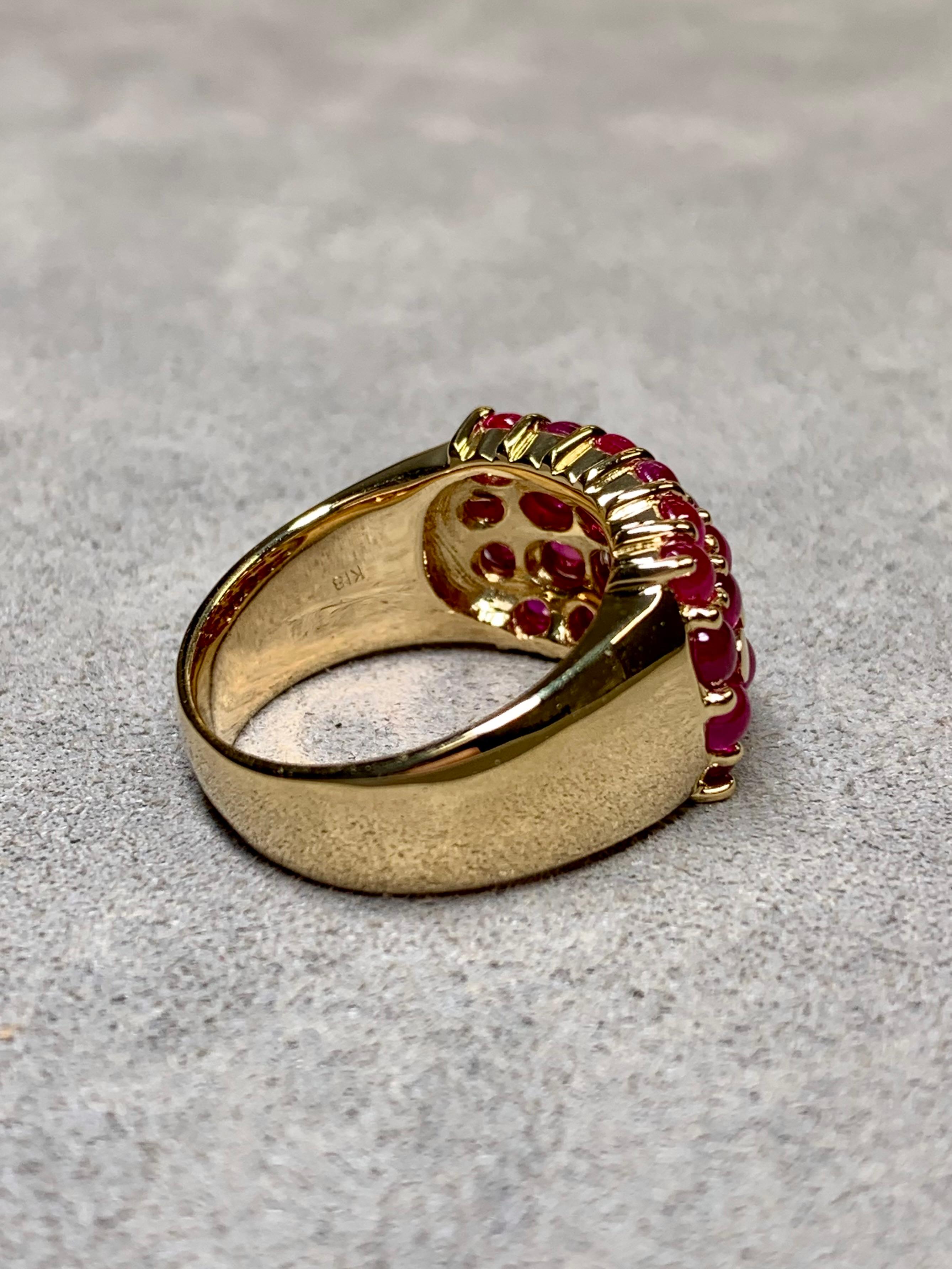 An exceptionally well-made ring crafted in 18K yellow gold and shared-prong set with numerous glowing, cabochon cut natural rubies. Total approximate ruby weight is 5ctw.


Dimensions/Weight:

Ring measures .45” top to bottom and weighs 12g. Size