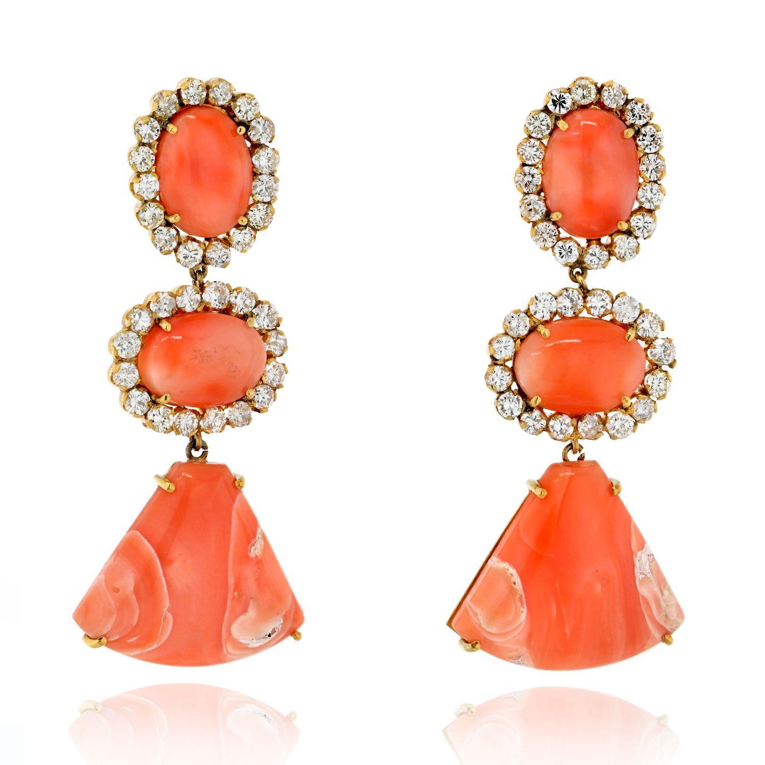 Glamorous and captivating this pair of Estate 18K Yellow Gold Coral and Diamond Dangling Drop Earrings is a true embodiment of elegance and allure. These exquisite earrings feature a design that seamlessly combines the natural beauty of coral with