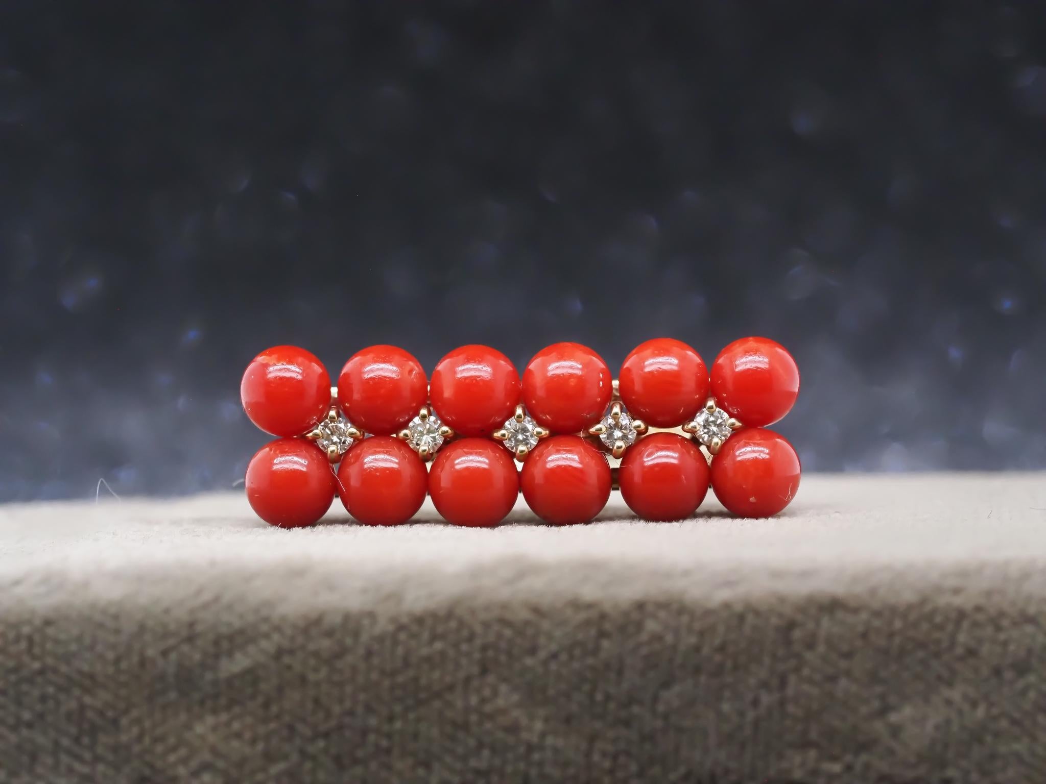 Year: 1990s

Item Details:
Ring Size: 6.5 (Sizable)
Metal Type: 18K Yellow Gold [Hallmarked, and Tested]
Weight: 5.8 grams

Coral Details: 5mm each, 12 stones, red, undyed, natural

Diamond Details: Round Brilliant, Natural Diamonds, G Color , VS