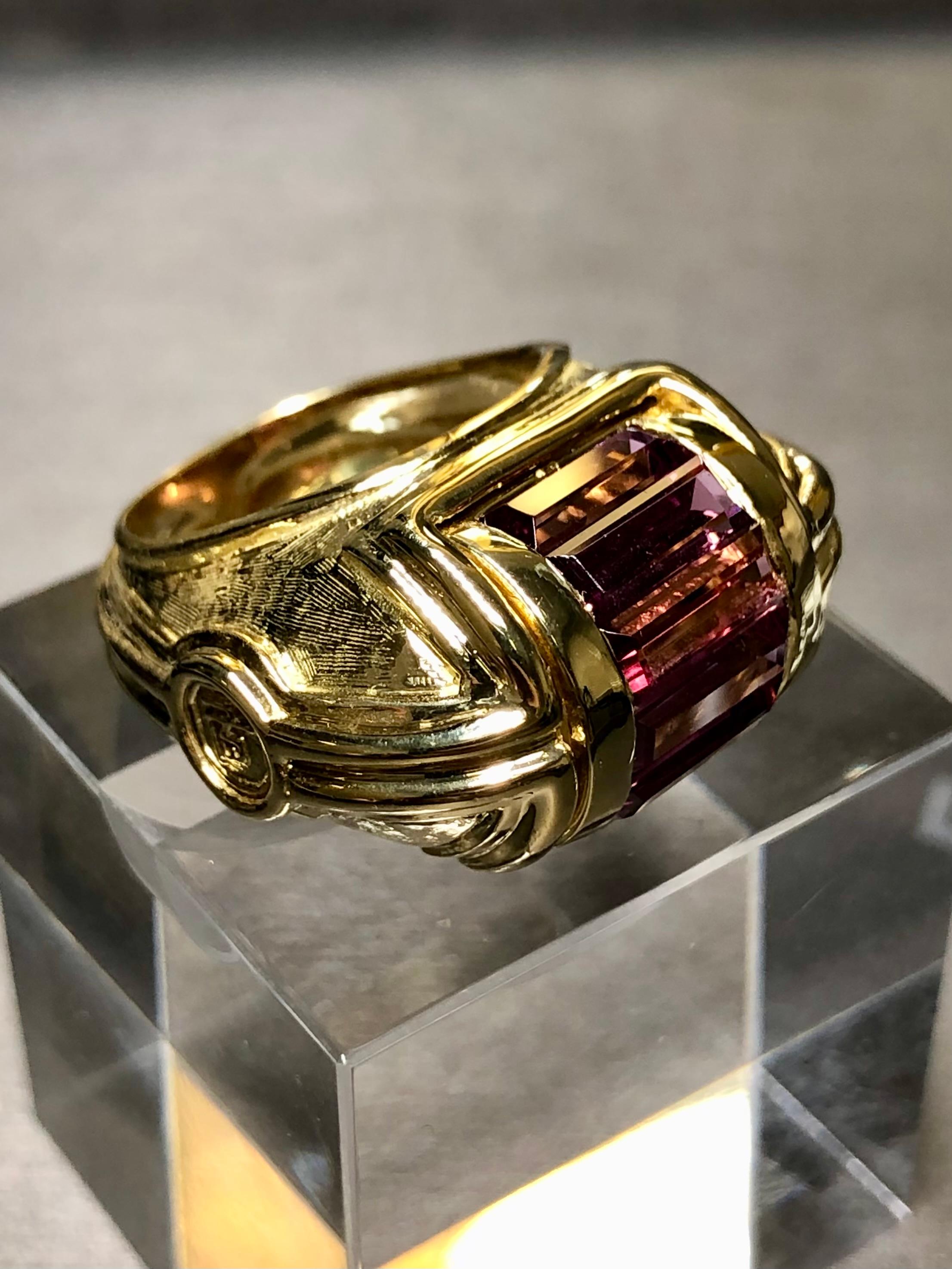 
A contemporary and bold ring done in heavy 18k yellow gold set with approximately 12cttw in natural elongated tourmalines across the center. This ring IS done by a particular designer, but no one that we are familiar with unfortunately. Beautifully