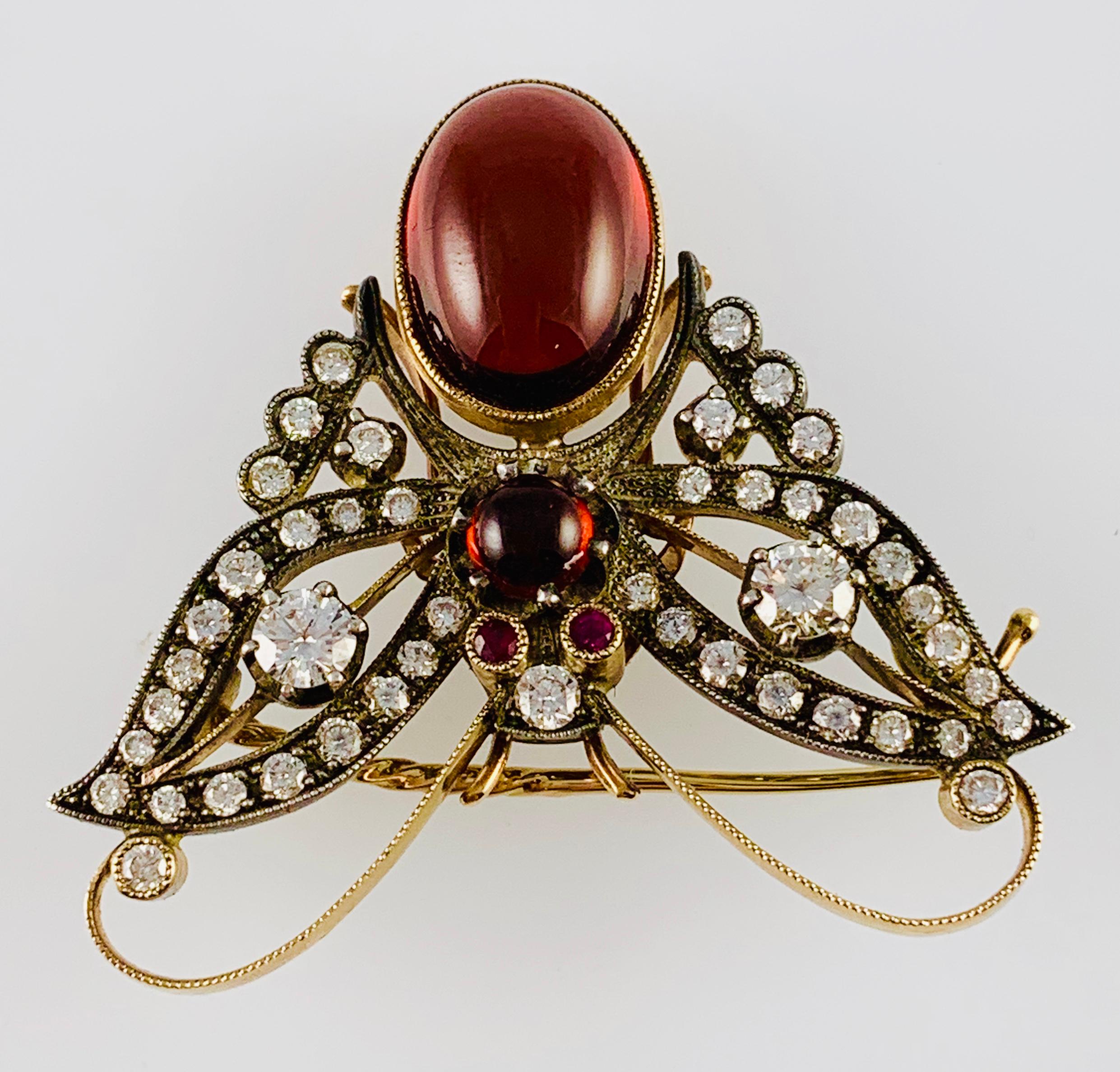 Beautiful Estate Butterfly Brooch! Made in 18k yellow Gold the butterfly has Ruby Eyes, Diamond Wings and two cabochon cut garnets that make up the body. There are 45 Brilliant Diamonds that are G-H Color & Vs2 clarity. The diamonds have an